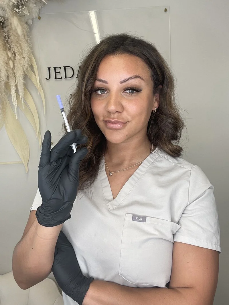 Aesthetics treatment specialist standing in Stafford clinic holding needle