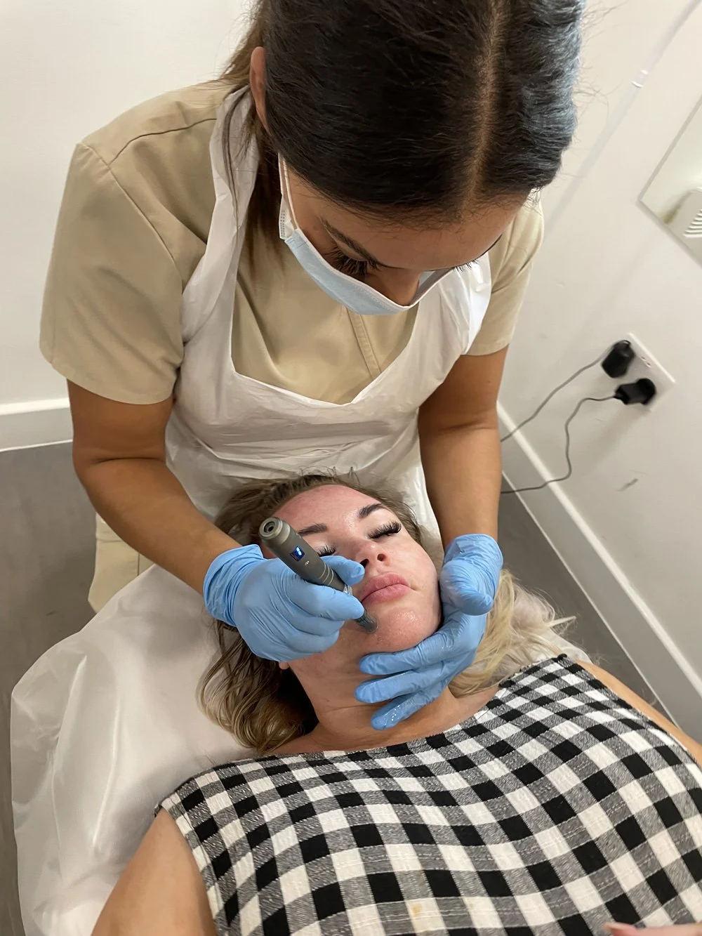 Woman having aesthetic treatment in Stafford clinic