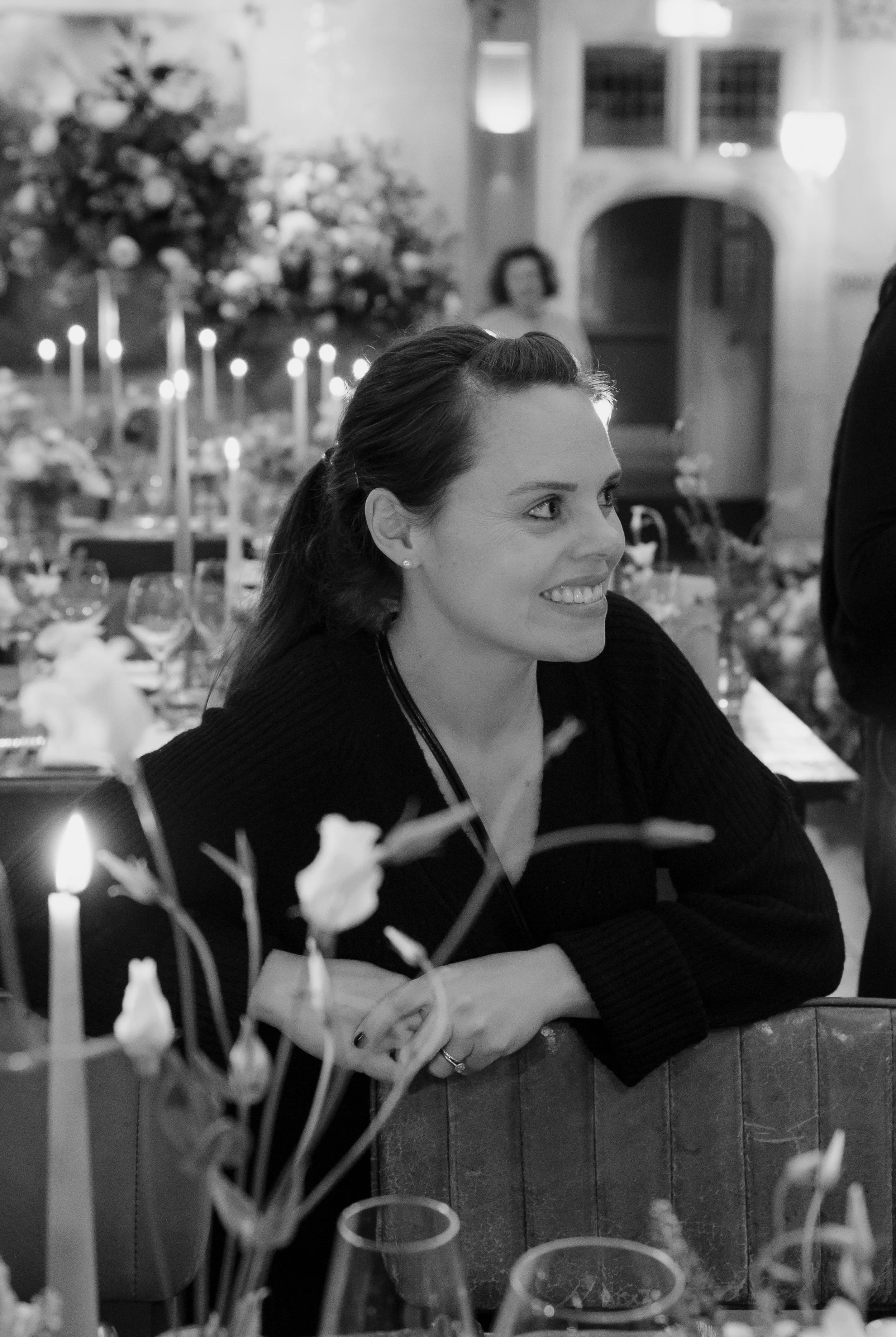 Georgie, wedding planner, smiling on as she witnesses her bride and groom see the wedding breakfast space for the first time.