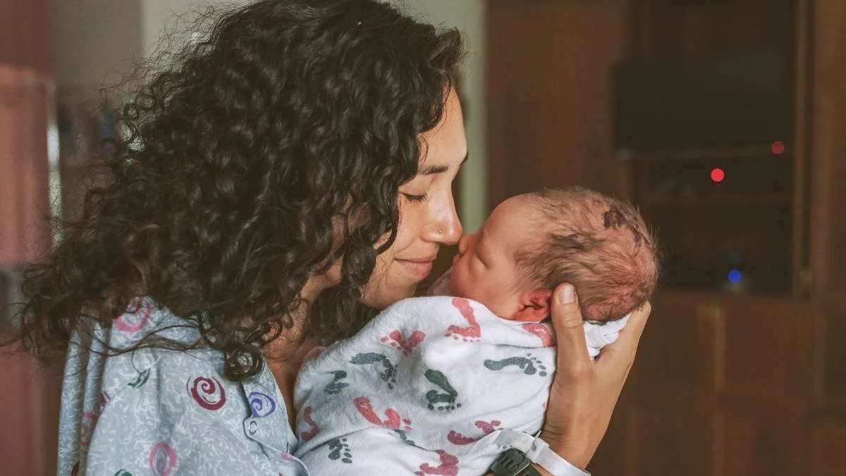 New mother holding baby in Postpartum Therapy 