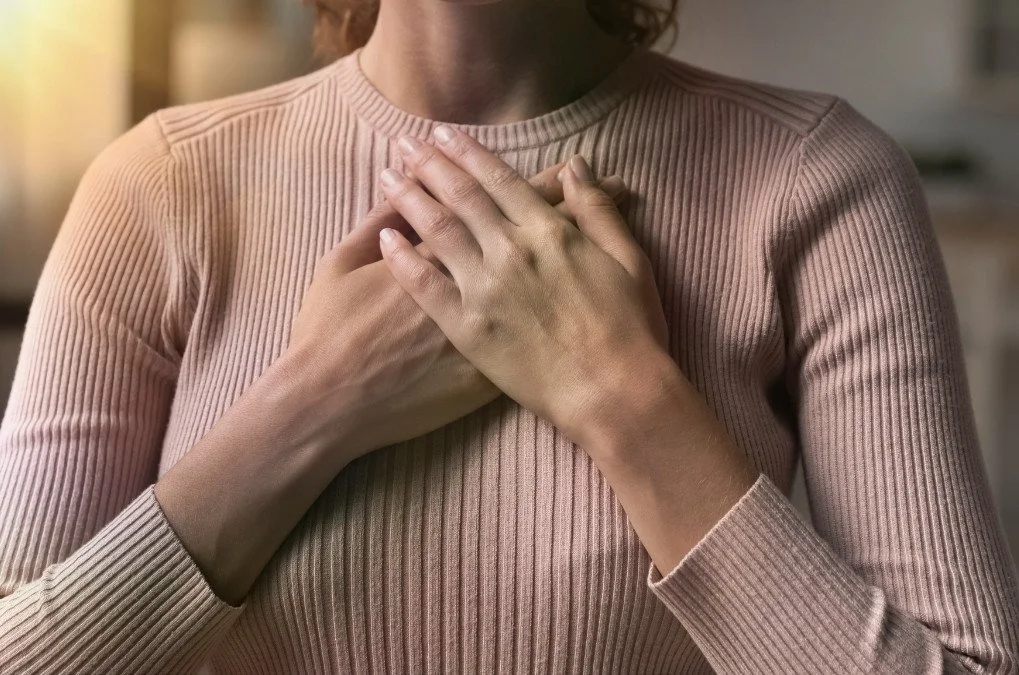 Soft abstract background of woman with hands crossed over her heart.for the section: EMDR Therapy in Brooklyn. & Virtual