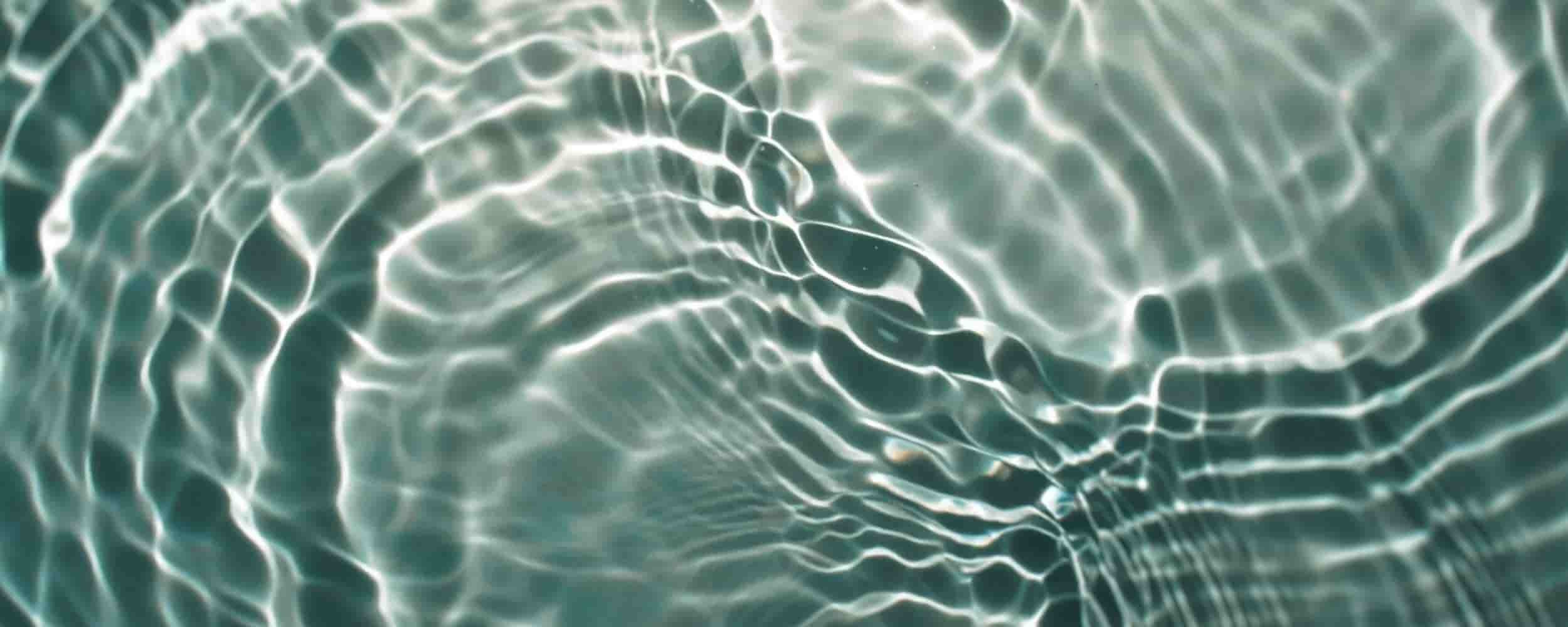 Sunlight reflecting through rippling water background for the section: We Focus on Patterns, Not Just Problems