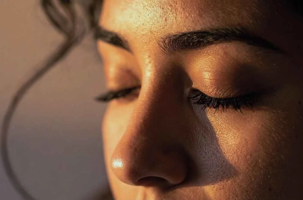 Close-up of a woman's closed eyes.