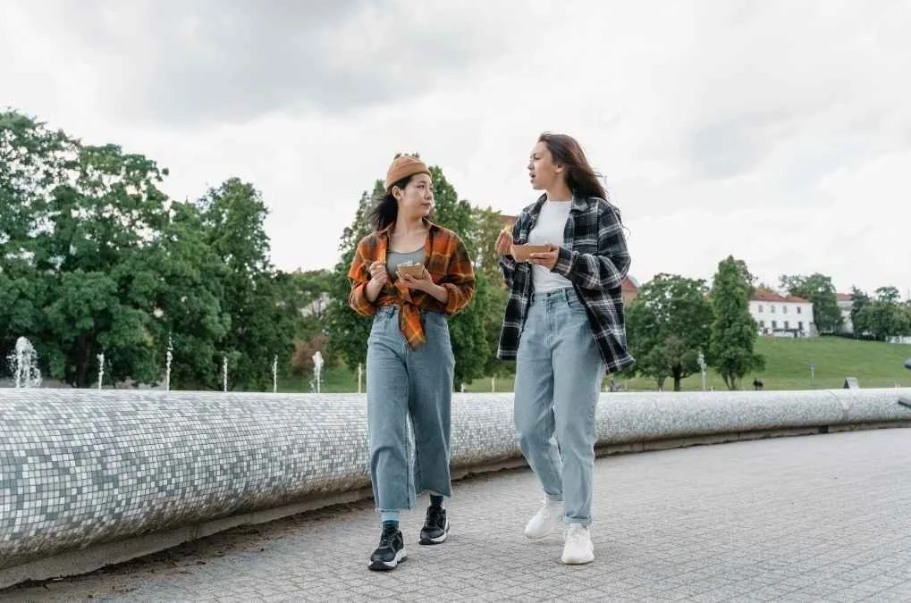 Two women walking and talking.