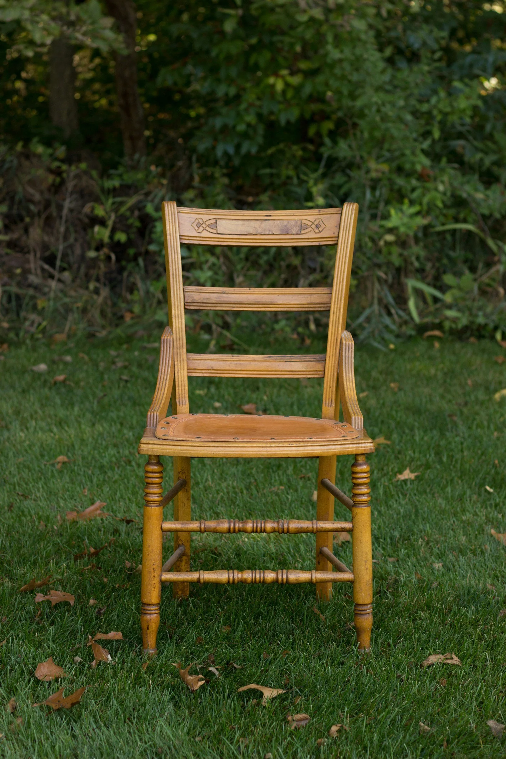 Old wooden chair sat on grass
