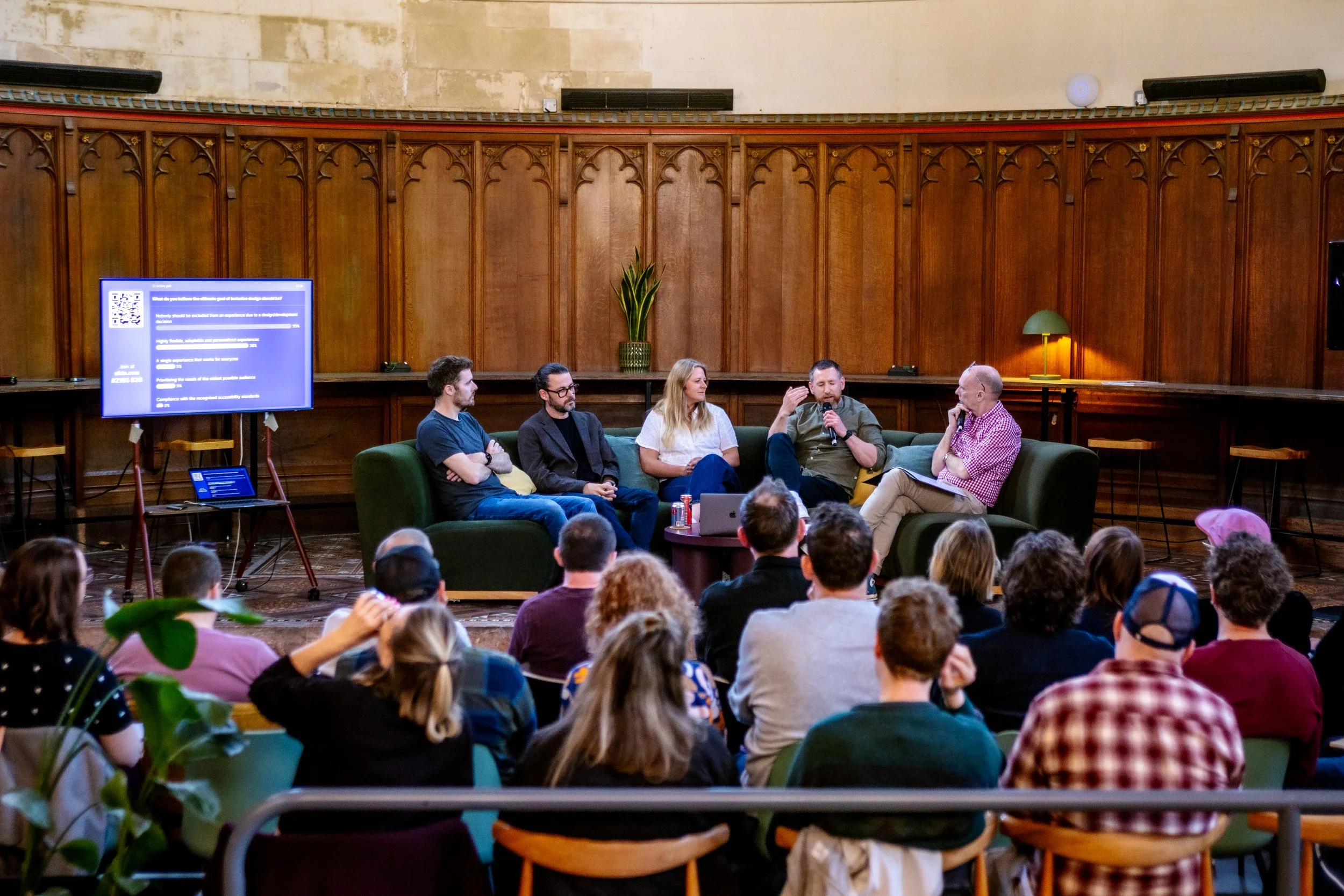 Five people sat on stage in front of an audience