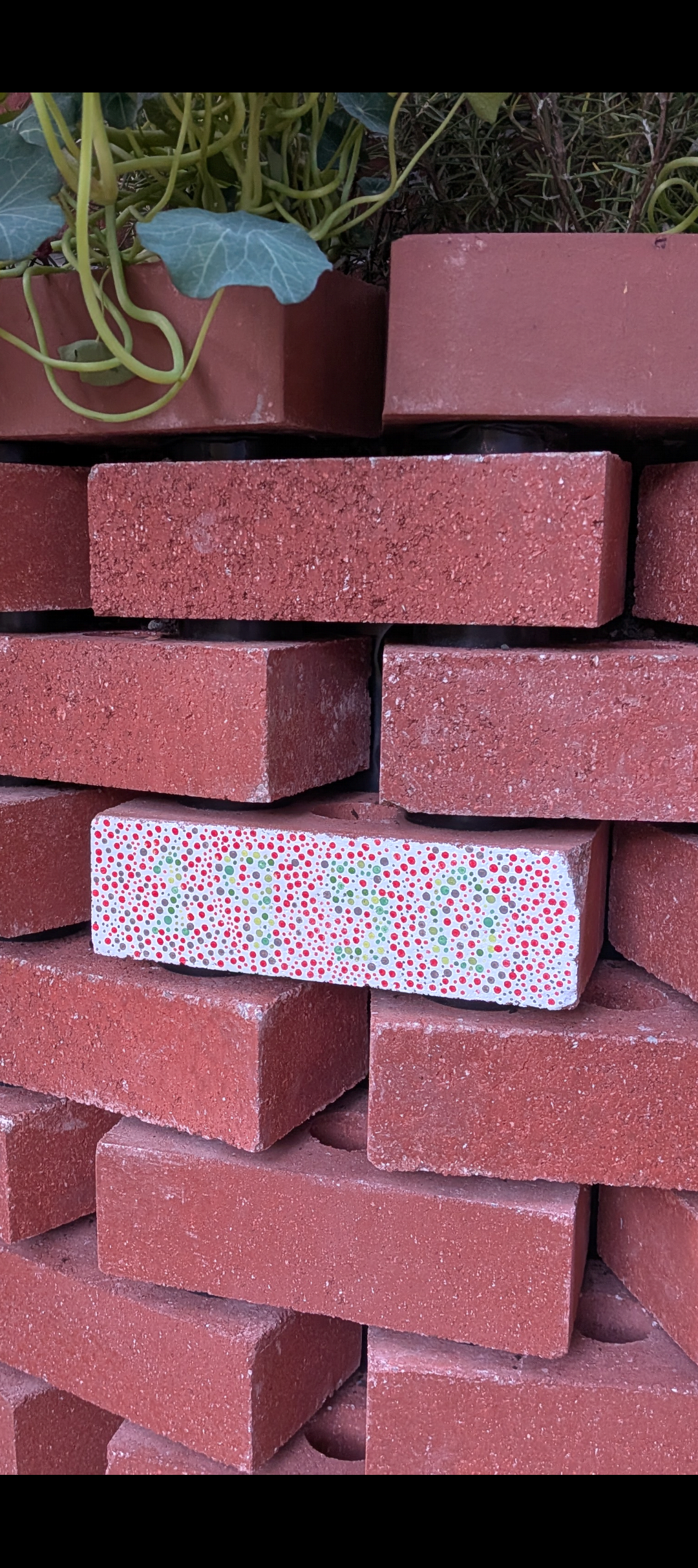 A brick wall with one painted brick in an ishihara style