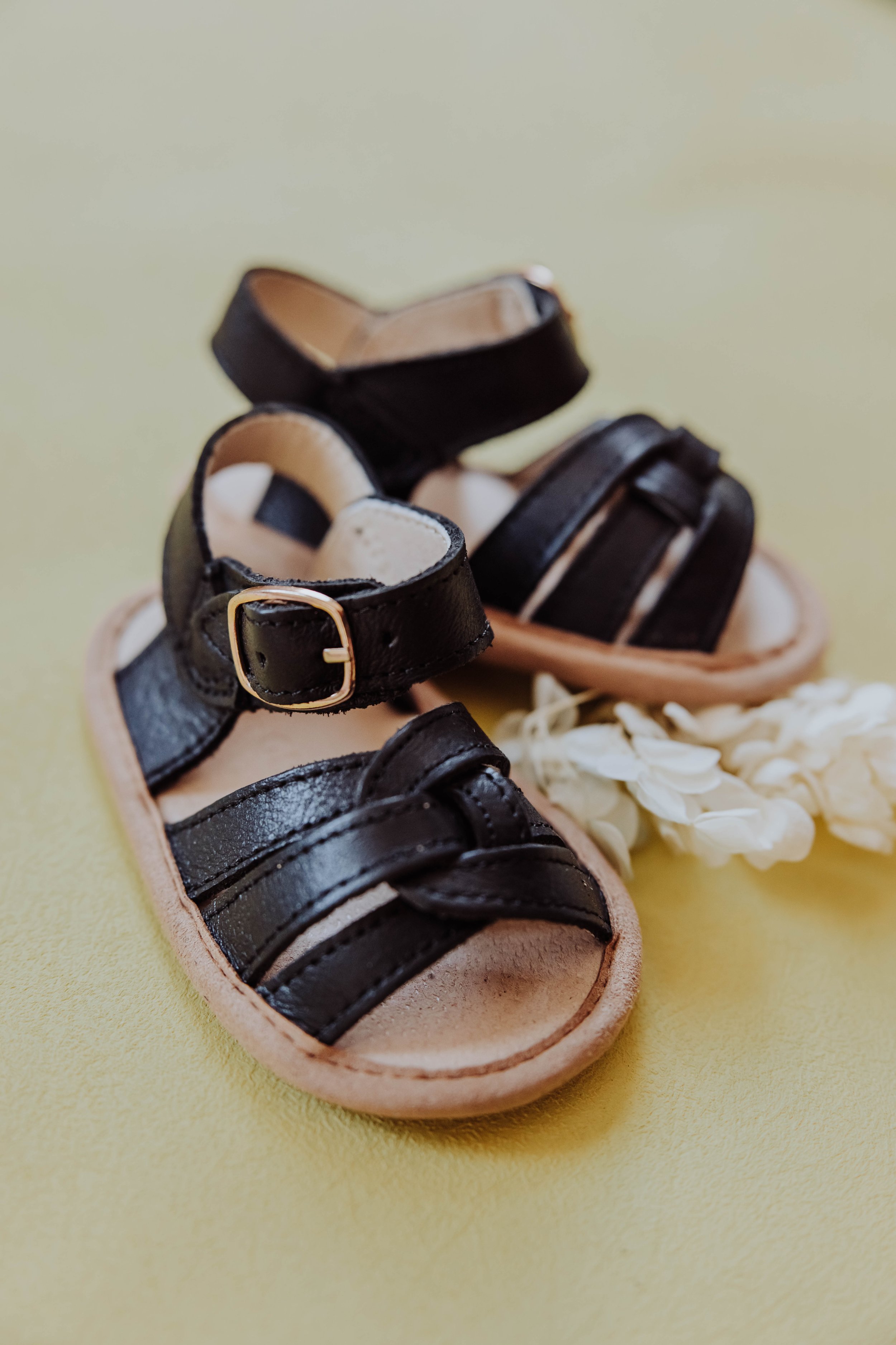   Styled product flat lay for children's clothing brand featuring neutral tones and intentional props.  