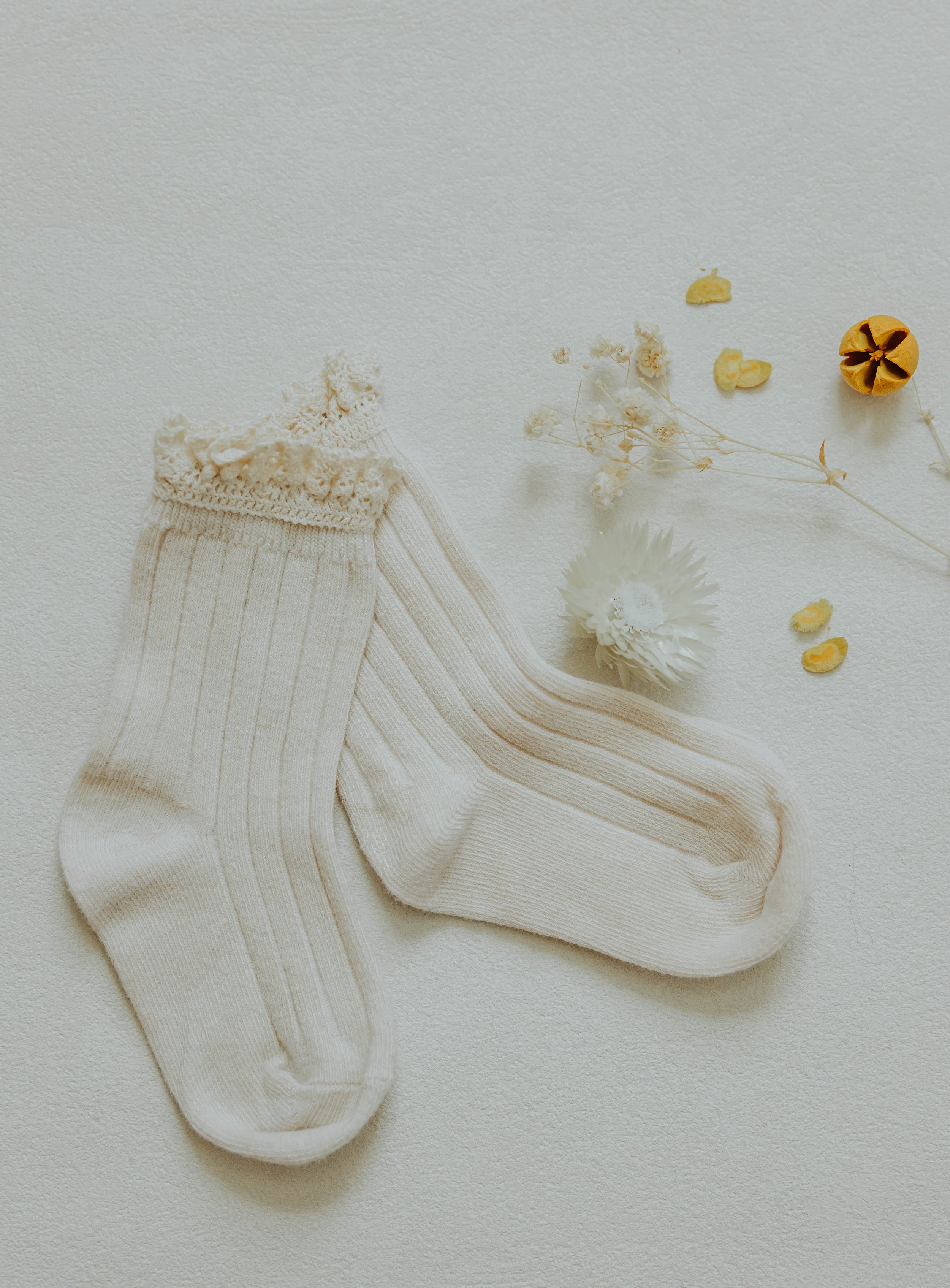   Styled product flat lay for children's clothing brand featuring neutral tones and intentional props.  