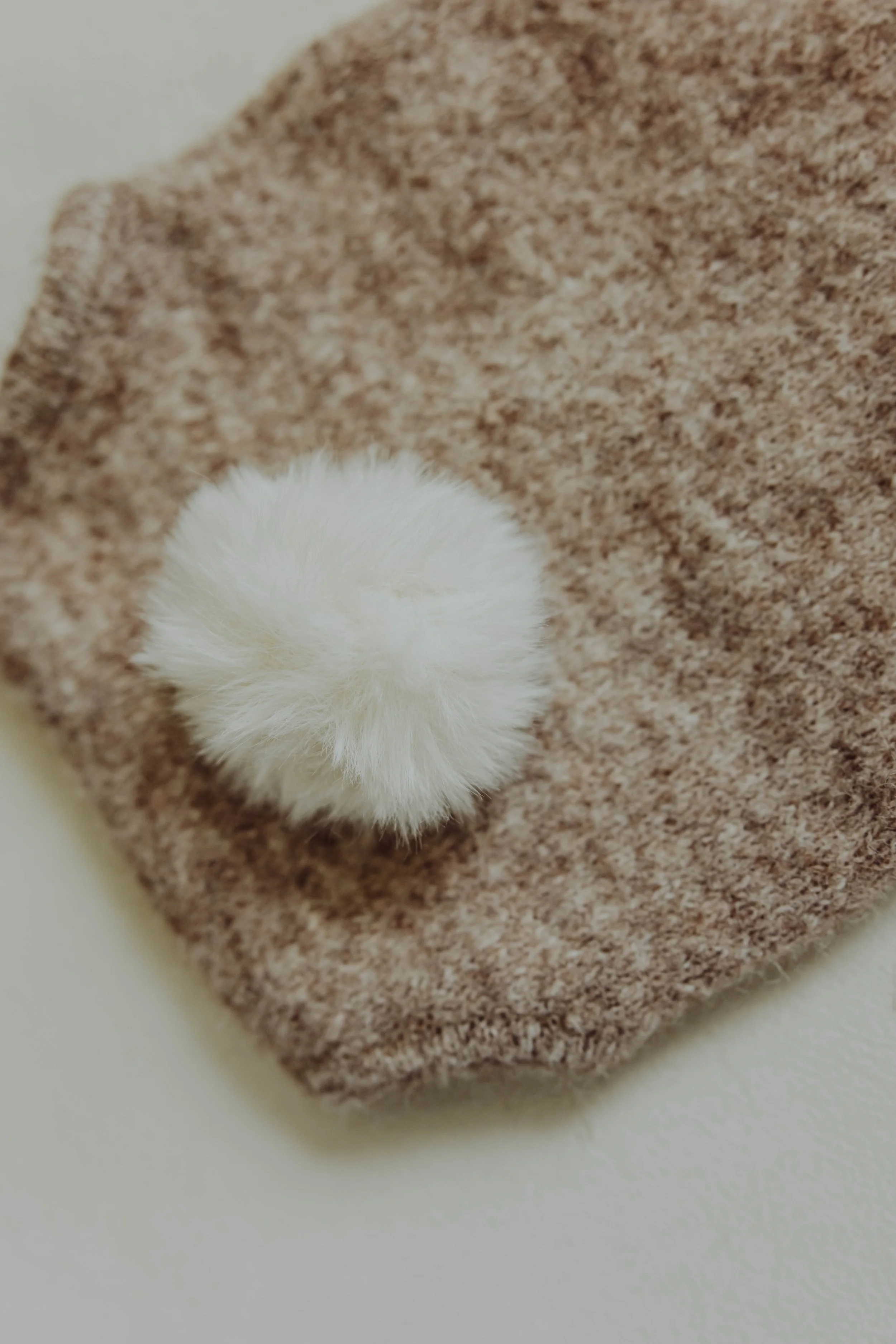   Detail product photo of children's clothing with natural light and textured styling props.  