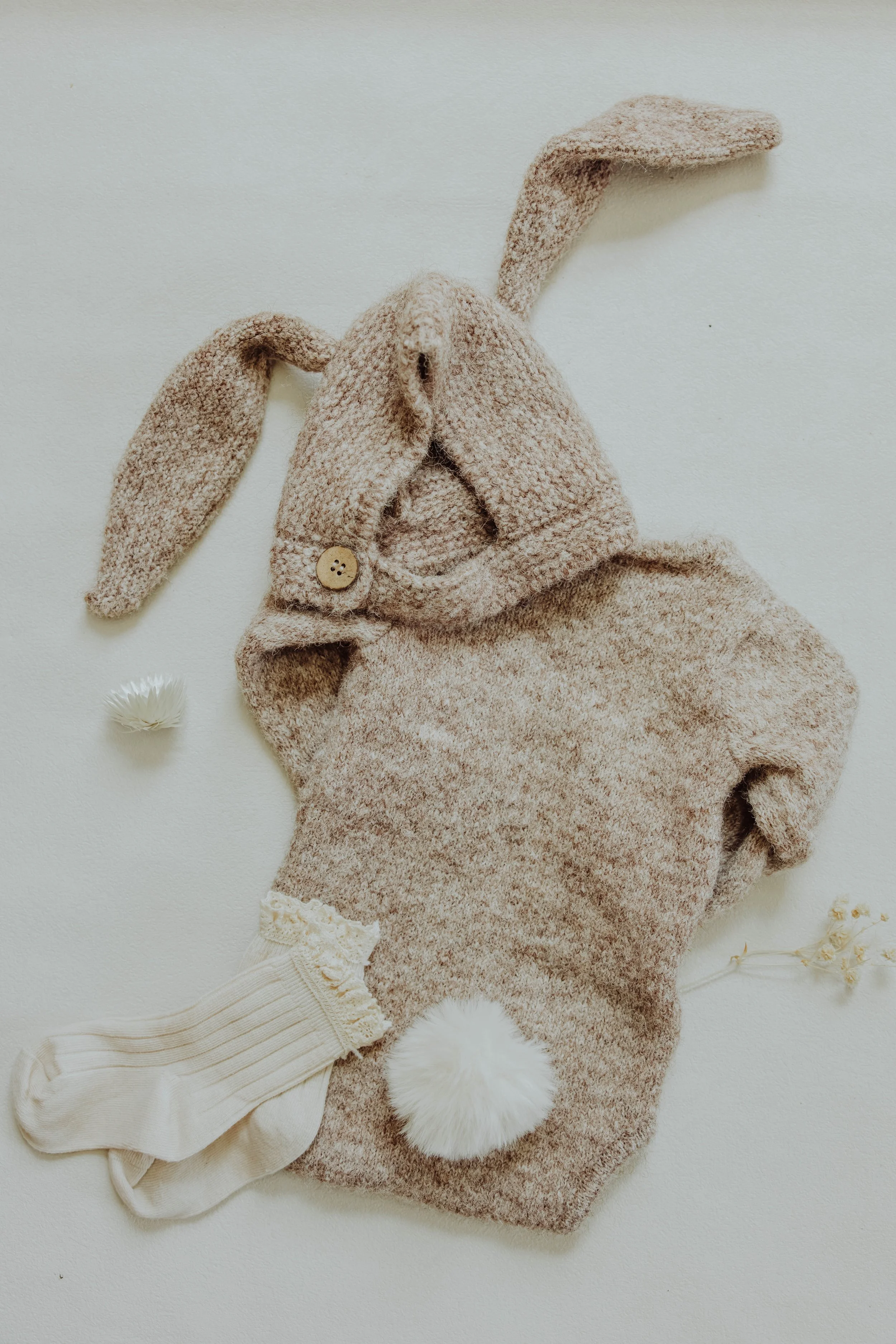   Detail product photo of children's clothing with natural light and textured styling props.  