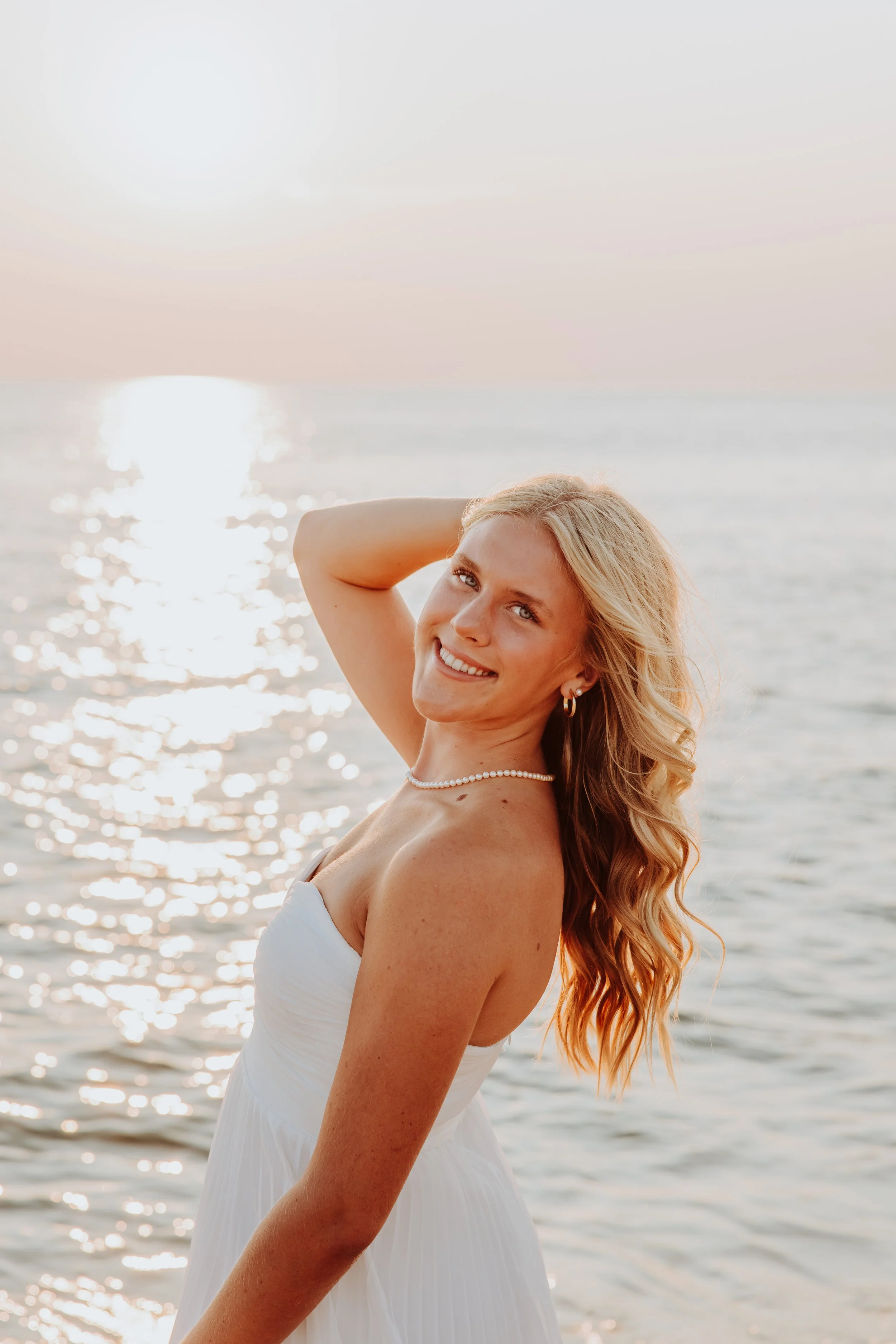 High school senior portrait on the beach at sunset at Lake Michigan