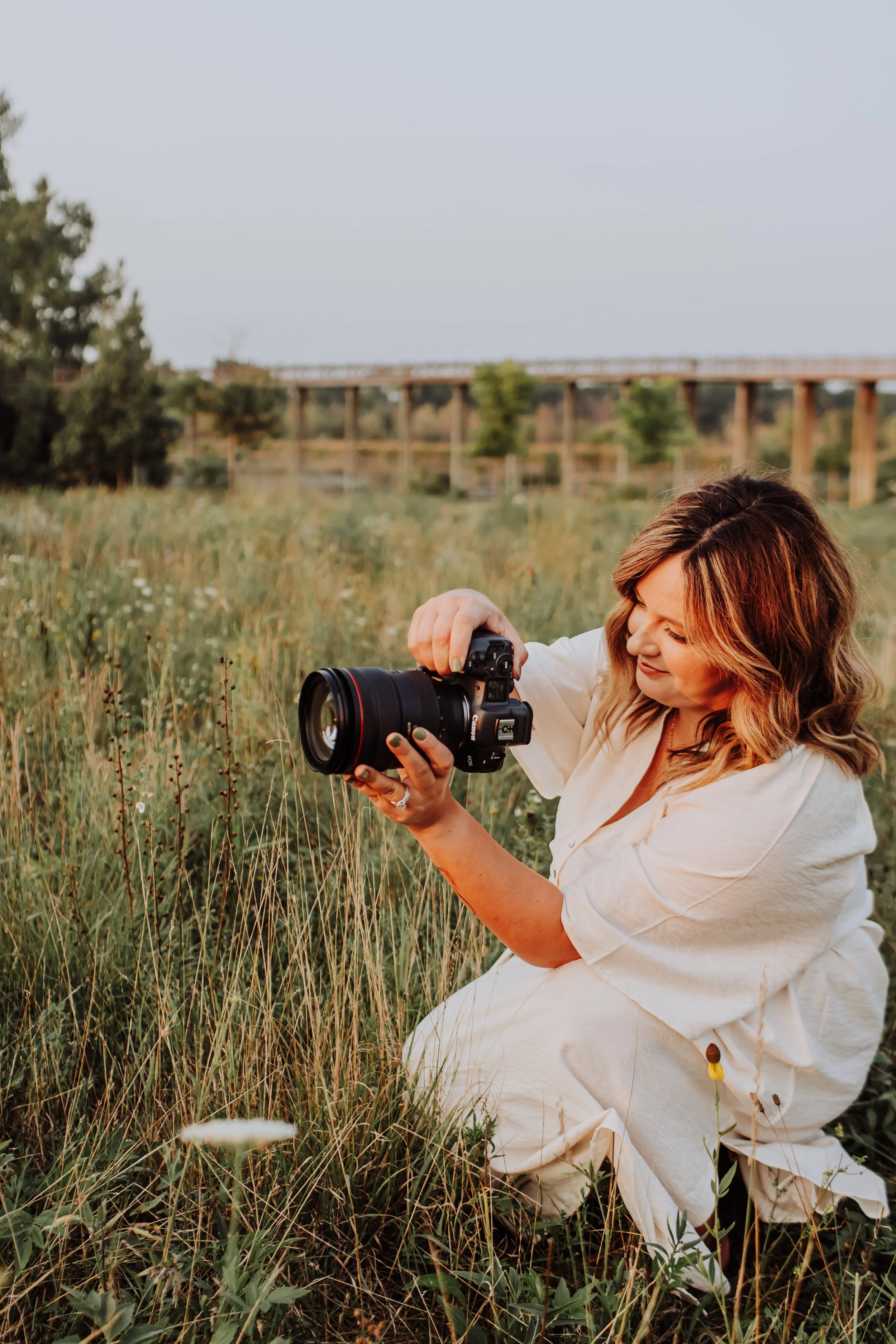 Lexie Marie photographing in a golden West Michigan field
