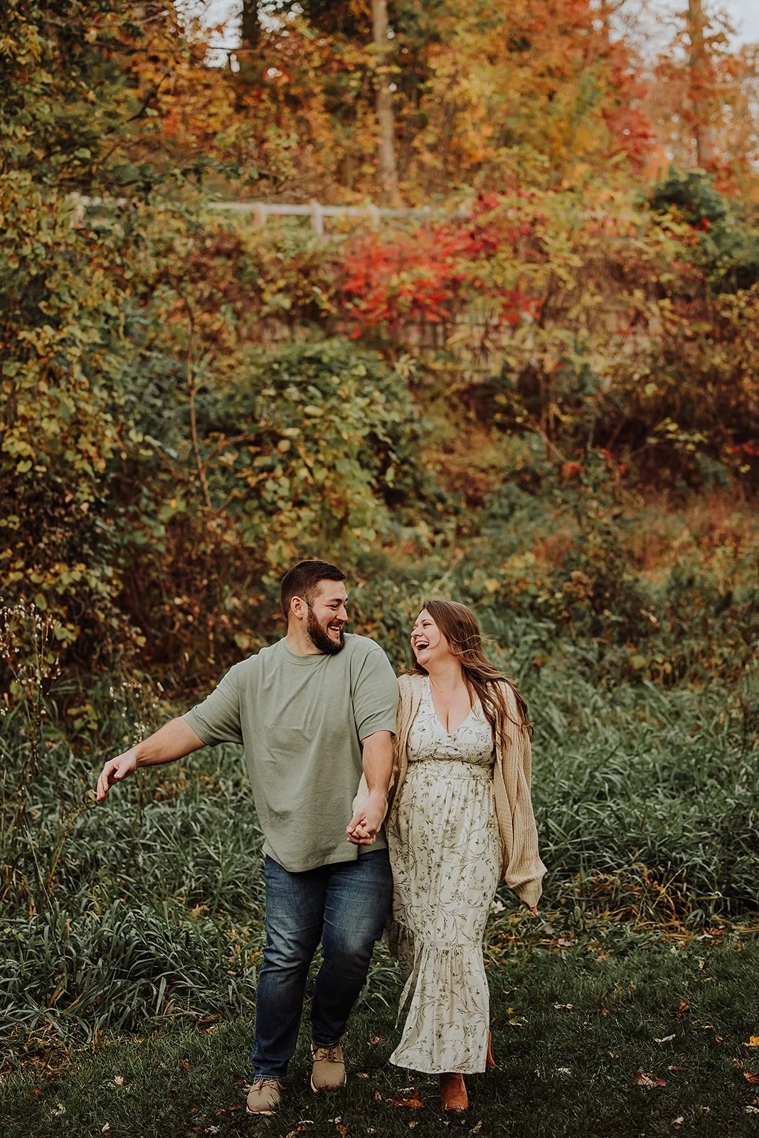 Fall engagement outfit idea: cream floral dress and knit cardigan, couple laughing at Grand Ravines