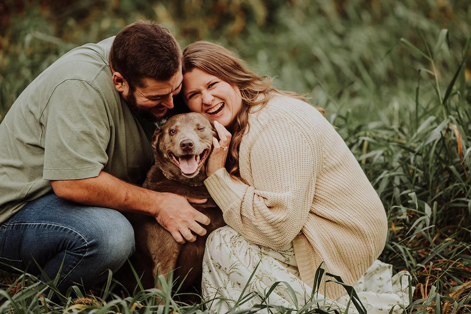 Engagement photos with dog: Rhen winking while Melissa laughs at Grand Ravines North Park