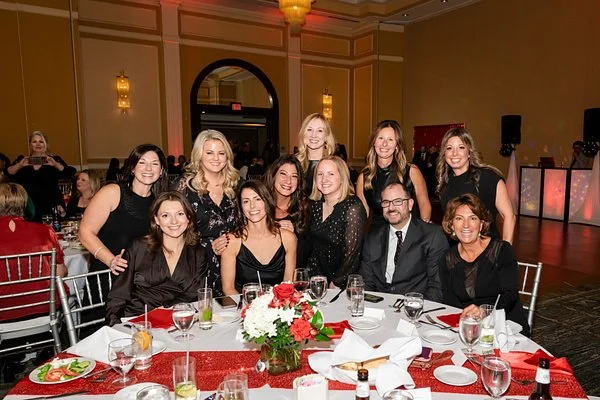 Large team group portrait photographed during a corporate gala