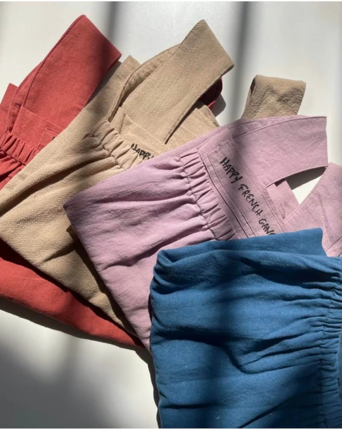 flat lay color happy french gang tanks