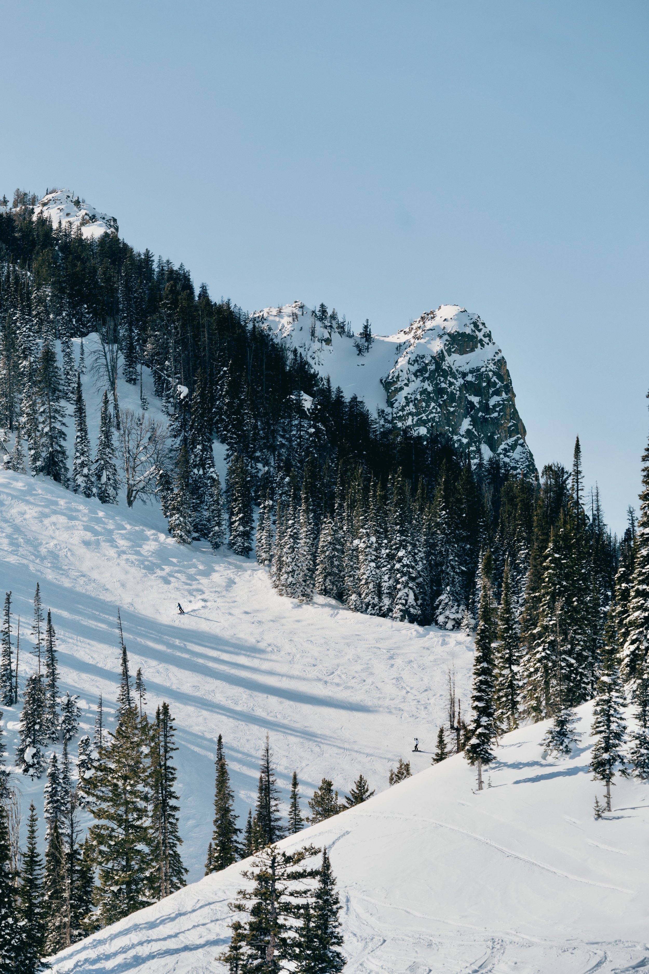 Skiers traversing the mountain