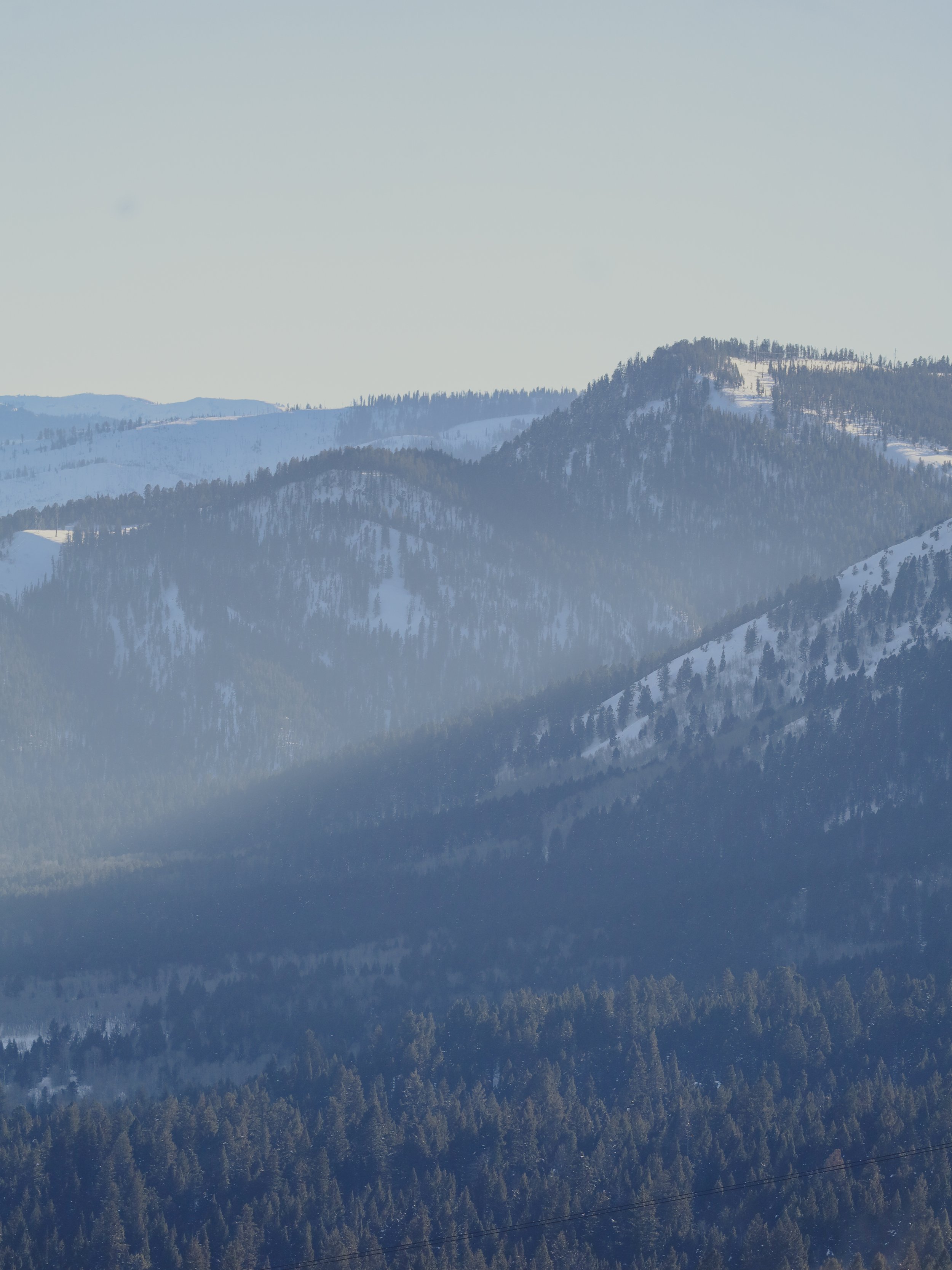 Layers of mountains lay in the late afternoon haze