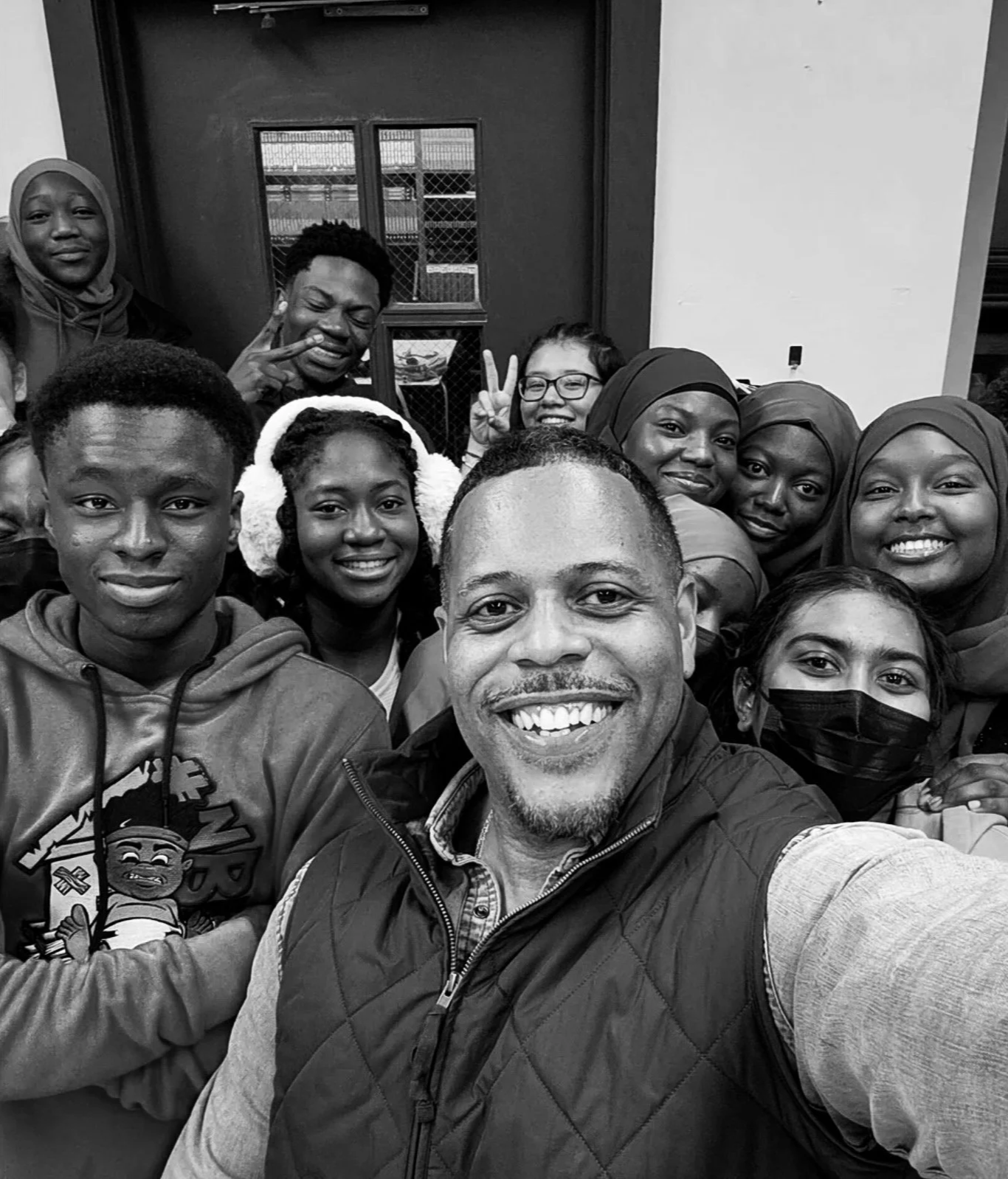 Black and white selfie photo of Joy Roots founder and students smiling