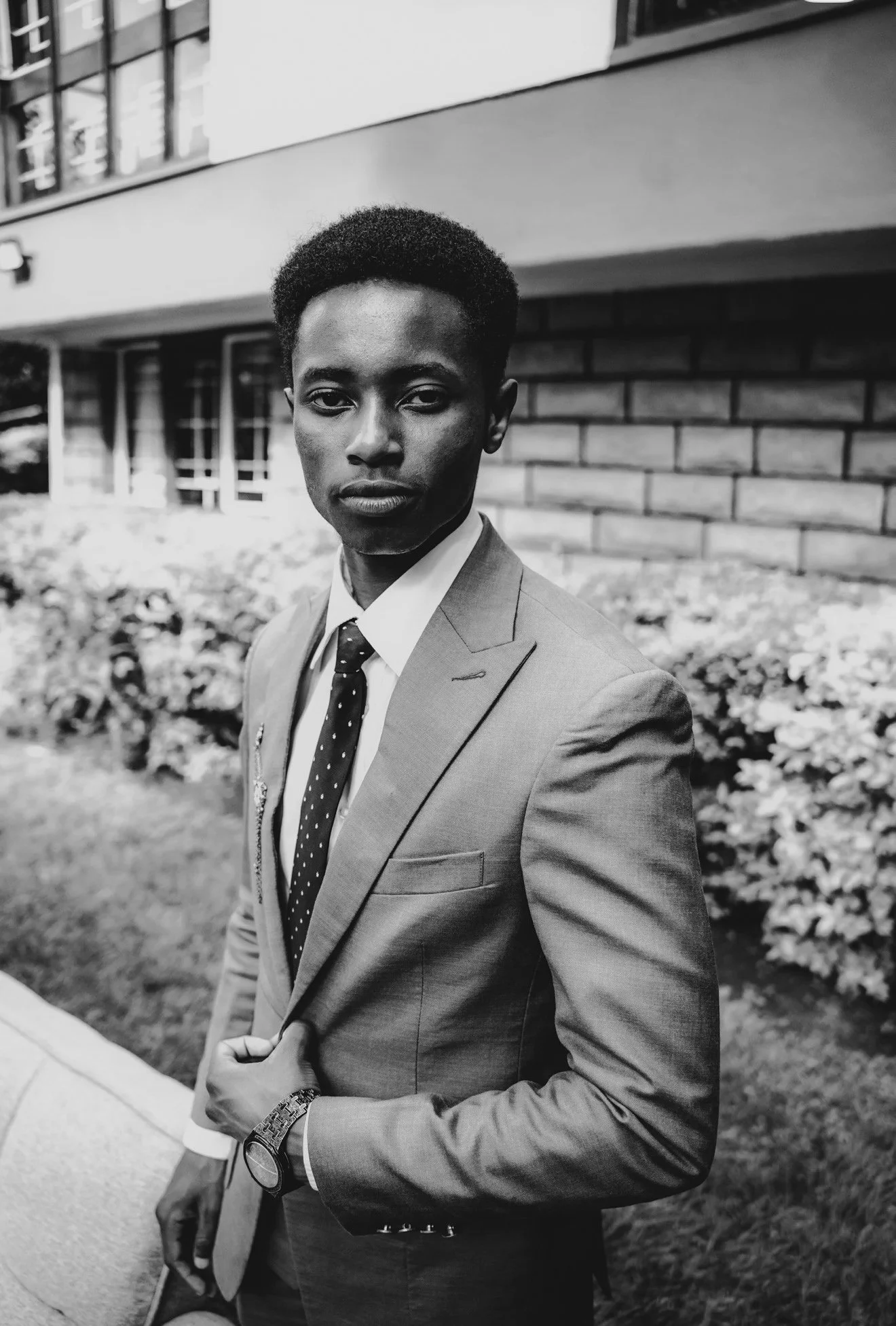 black and white photo of a young male student in professional suit