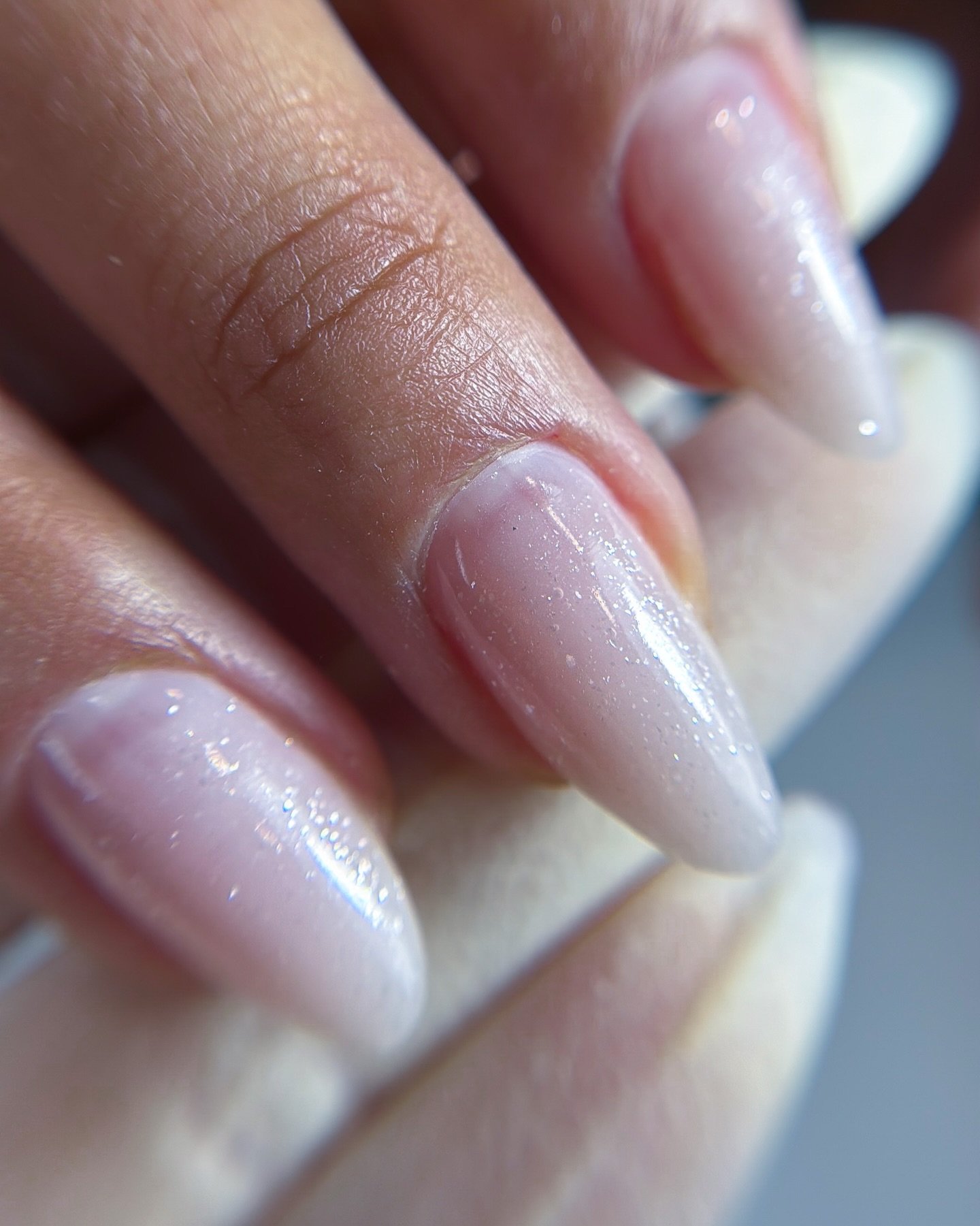 Subtle shimmer, refined structure. ✨

Short almond Dual Form finished with @mgartgel Moon Dust &mdash; a soft, luminous glow that elevates a natural look.

Appreciate the seamless transition from the cuticle area,
paired with a delicate, thin tip tha