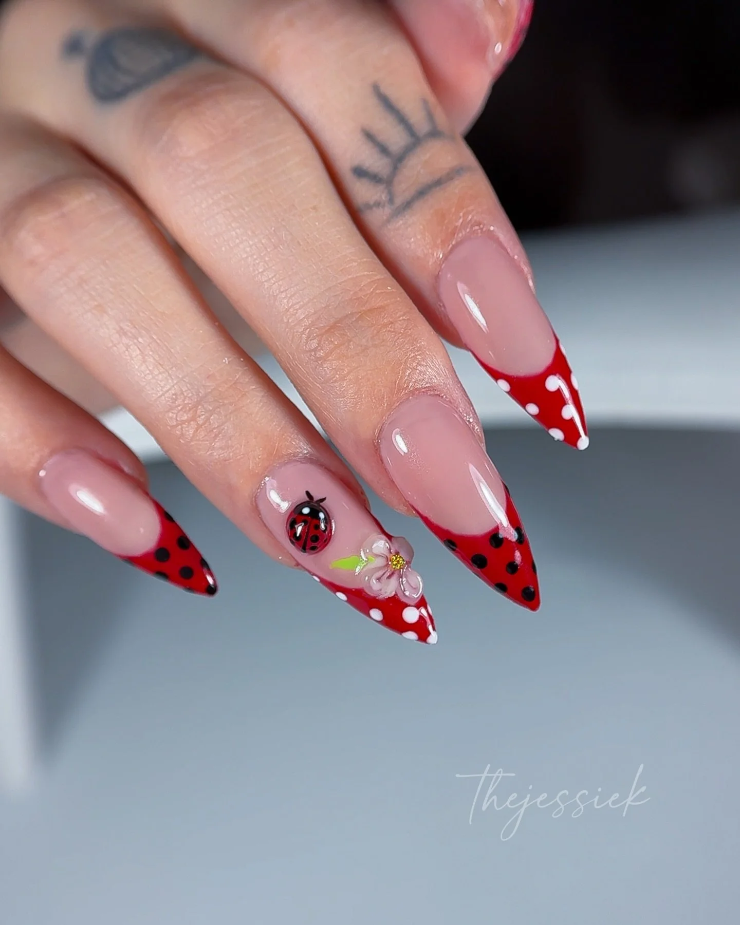 Cute&hellip; but make it bold 🐞❤️

Hand-painted ladybug, sculpted 3D flower, and sharp red French tips &mdash; the perfect mix of playful and edgy.

Every detail is hand-crafted to keep the nails looking thin, balanced, and wearable while still maki