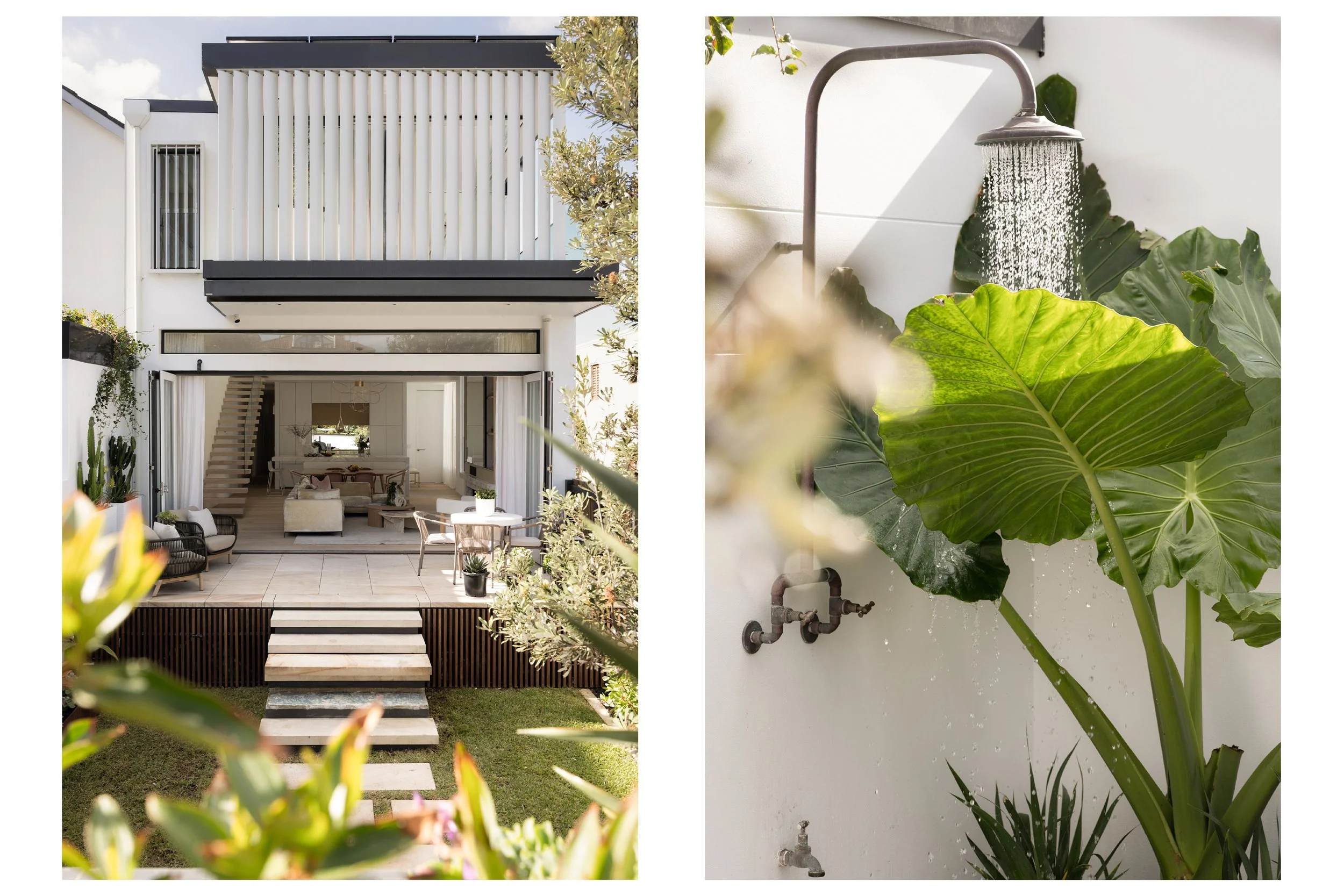 A modern two-story house with an outdoor patio area, white walls, and black accents, surrounded by lush greenery and plants, with a showerhead and large leafy plants on a white wall.