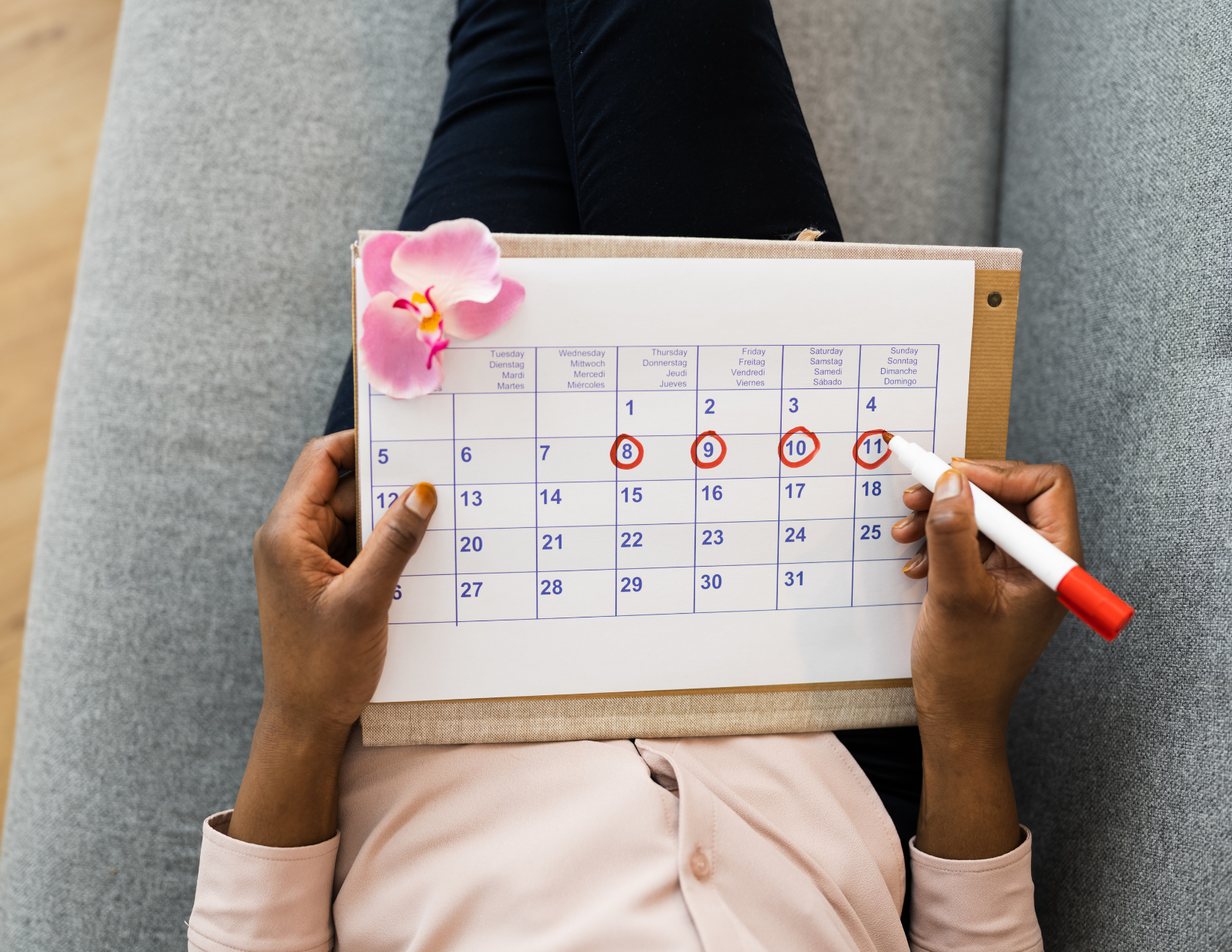 Woman circling her menstruation phase on a calendar — acupuncture for irregular cycles and PMS in NW Calgary