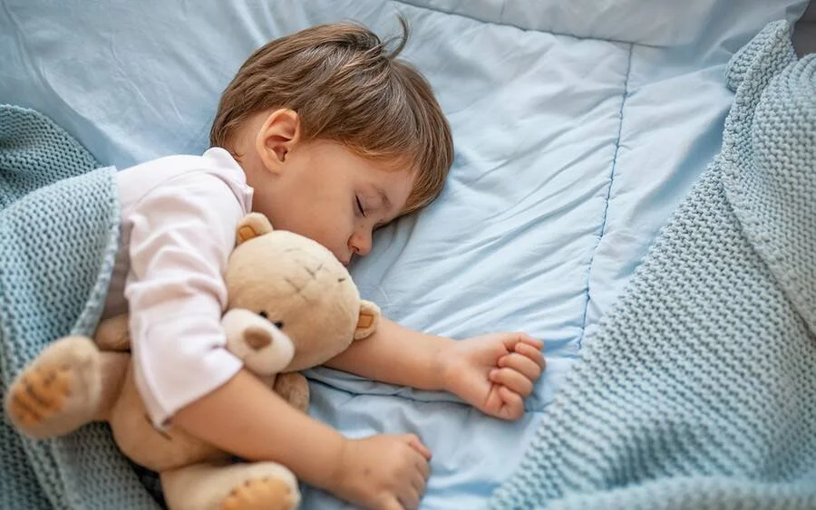 Child sleeping after acupuncture treatment in Calgary