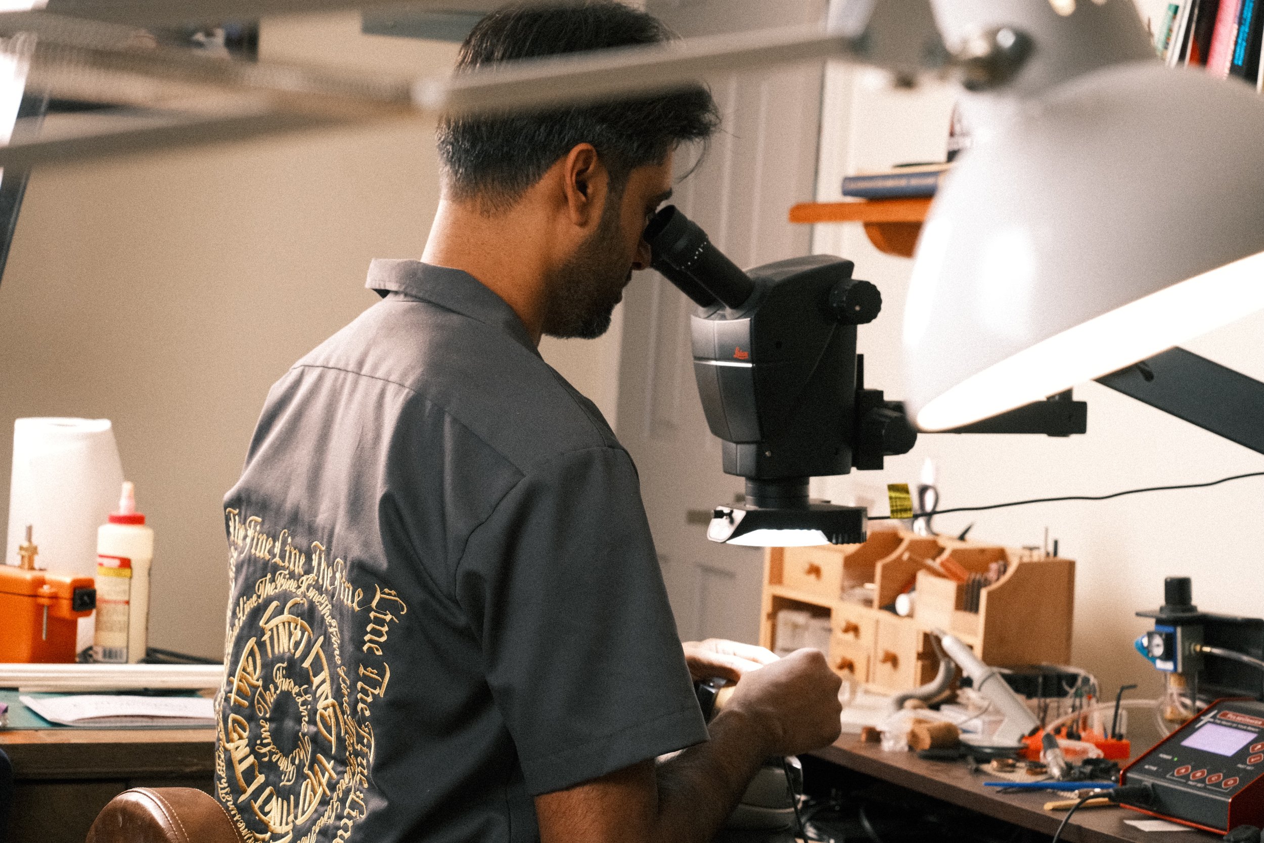 Calligraphy artist working under microscope