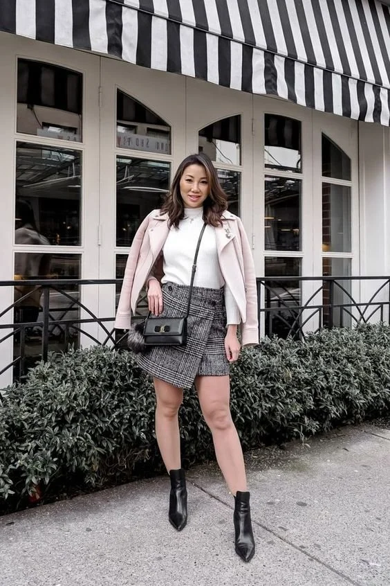 a-spring-work-look-with-a-white-turtleneck-a-grey-plaid-asymmetrical-mini-black-booties-and-a-pink-coat.jpg