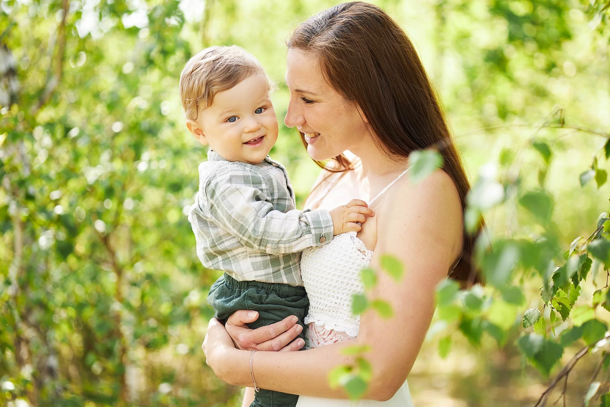 Eine junge Mama hält ihren Sohn in den Armen