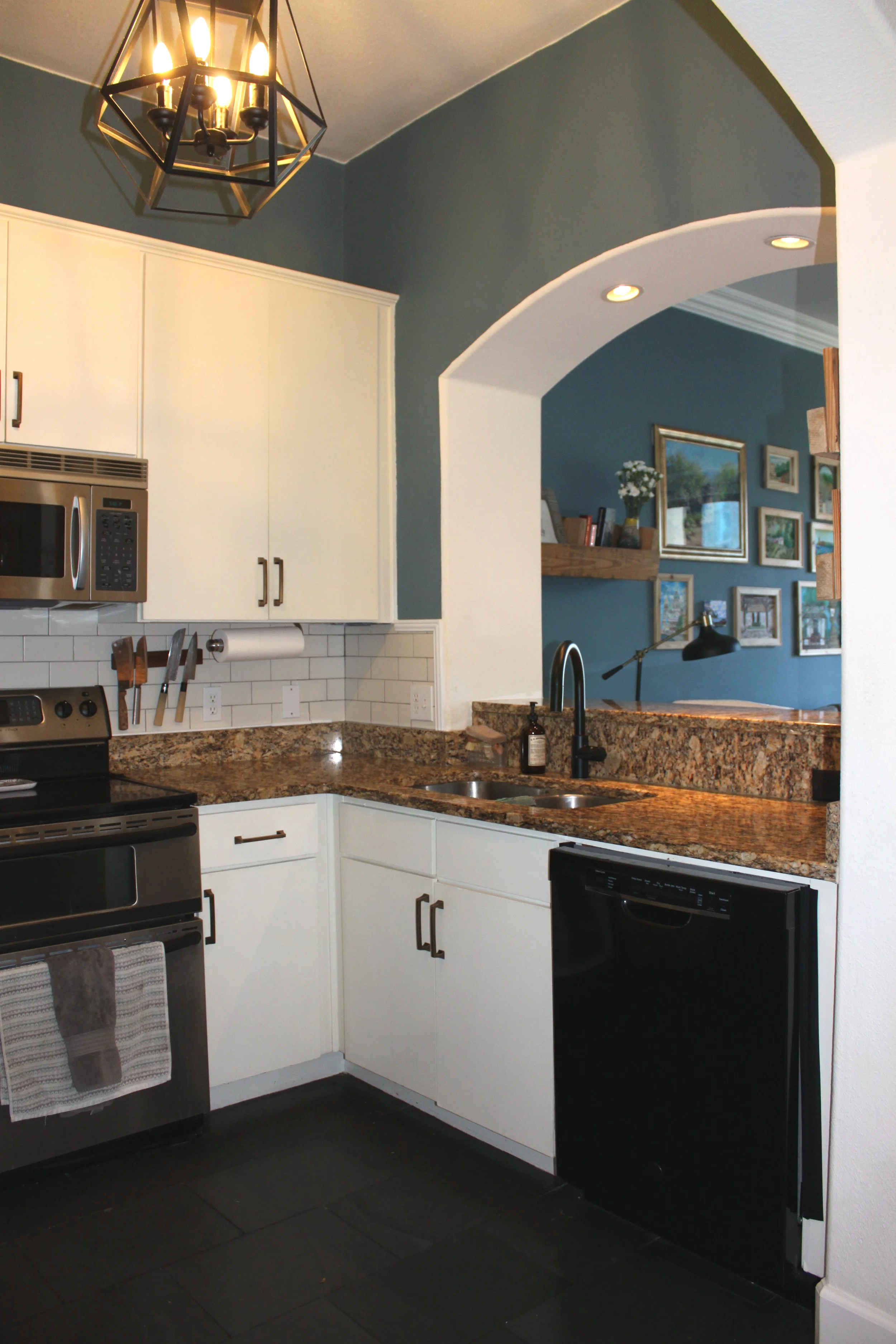 The kitchen cabinets were painted, a backsplash was added, and the light fixture updated.