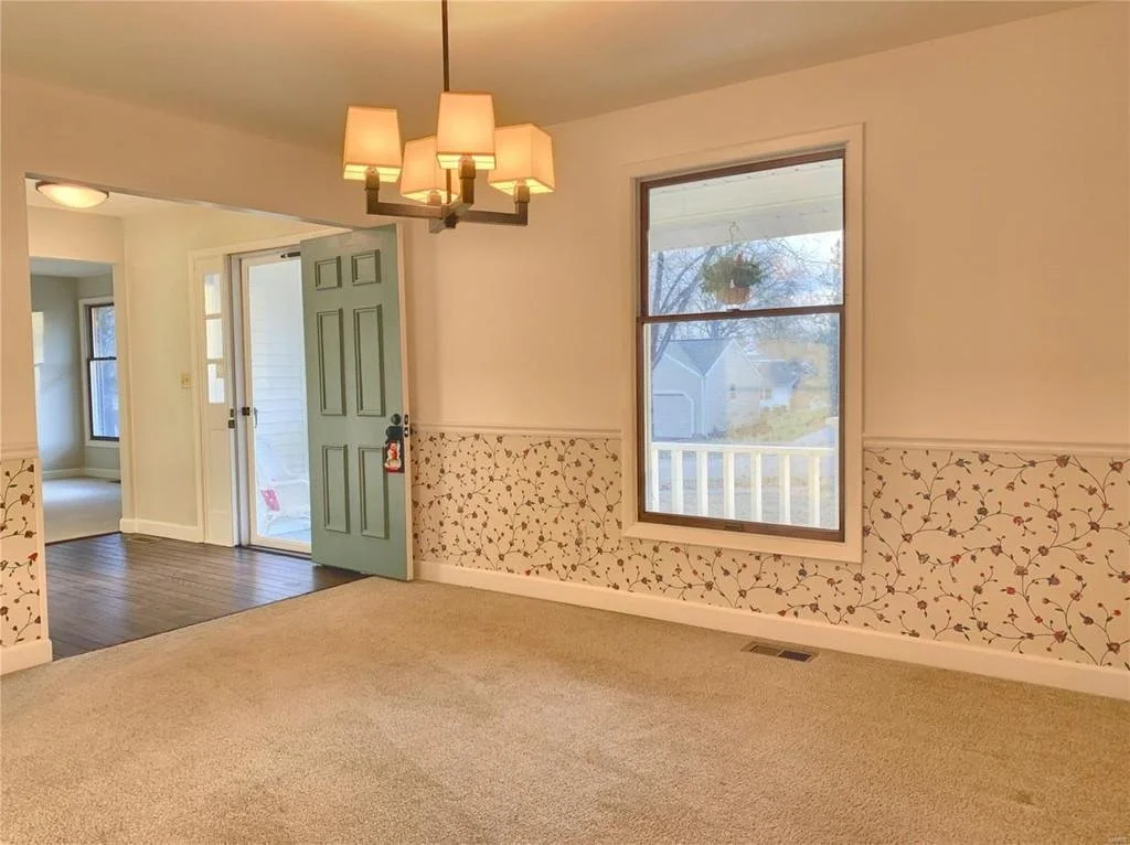 We kept the original wallpaper on teh bottom half, it was so cute and also another feature that we used to base our design off of. The light fixture was a reuse find.  We cleaned the carpet and refreshed the wood windows.