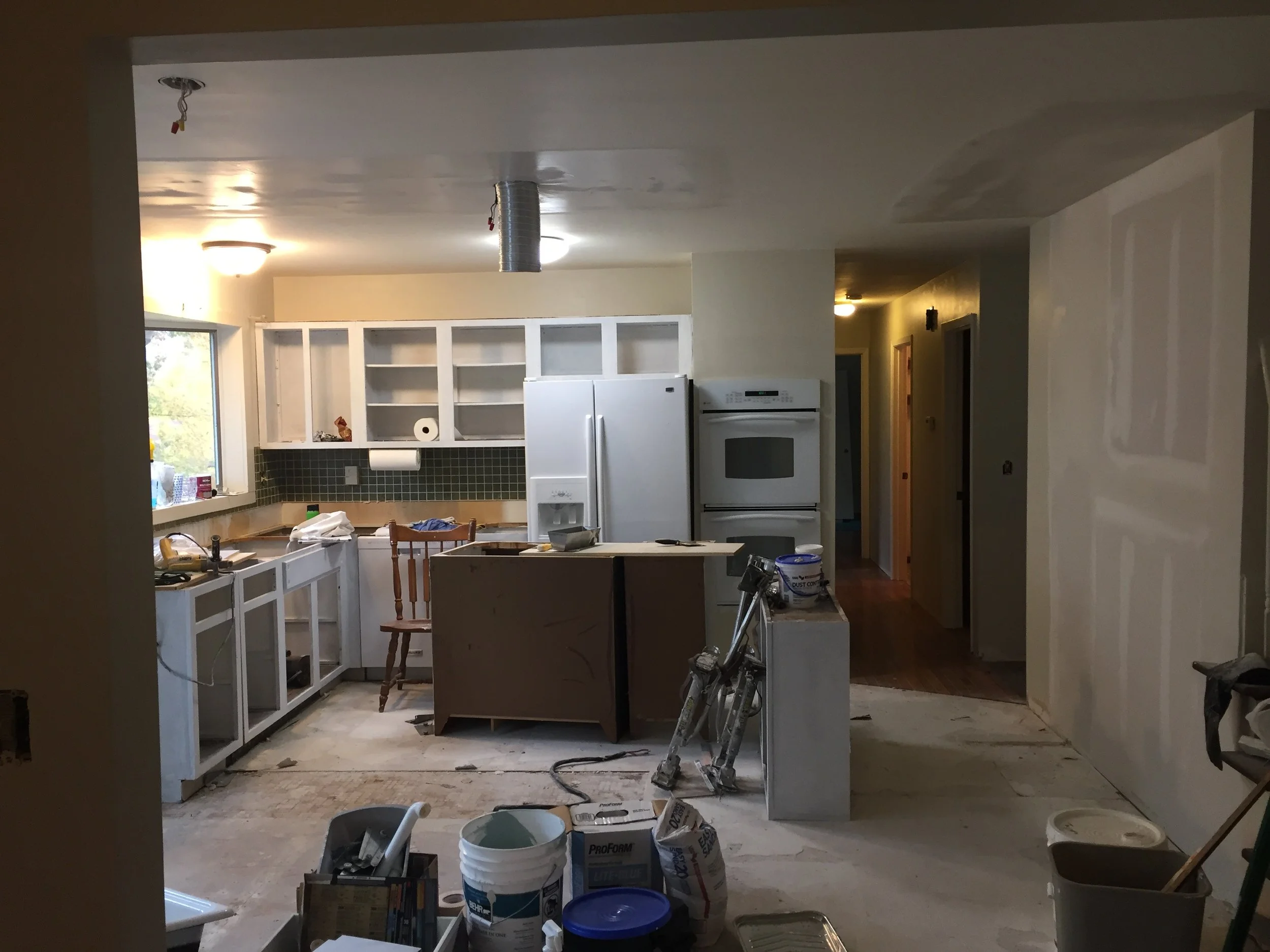 There was a pantry on the right-hand wall that also made the kitchen feel small, so we took it out and added a side counter.  Original laminate countertops were replaced with granite.