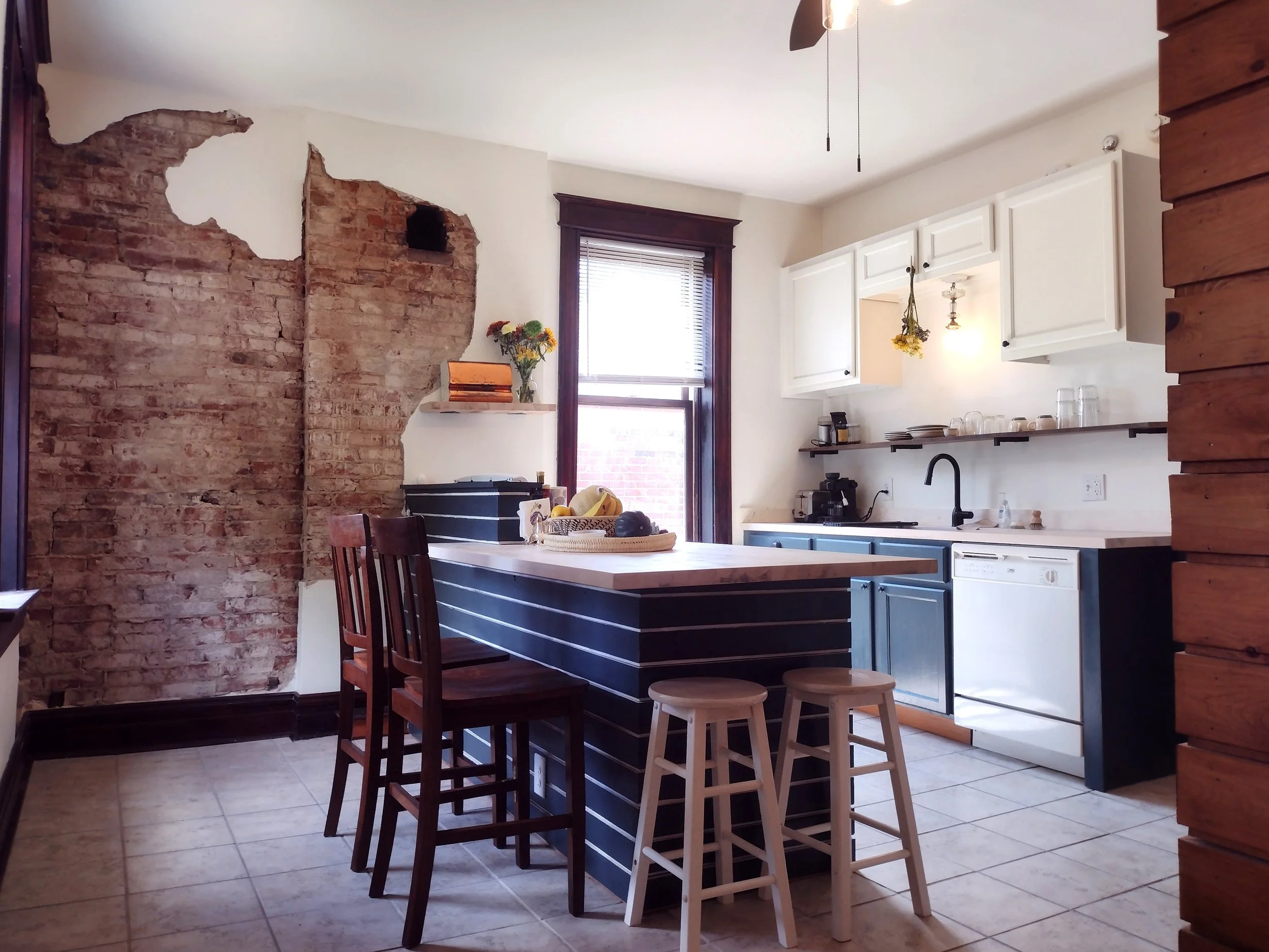 A lot of work went into this kitchen, which you can hardly see when you look at the before photos.  Cosmetically, we repainted the cabinets, installed shelving, new light fixtures, new faucet, and new butcher block countertops.