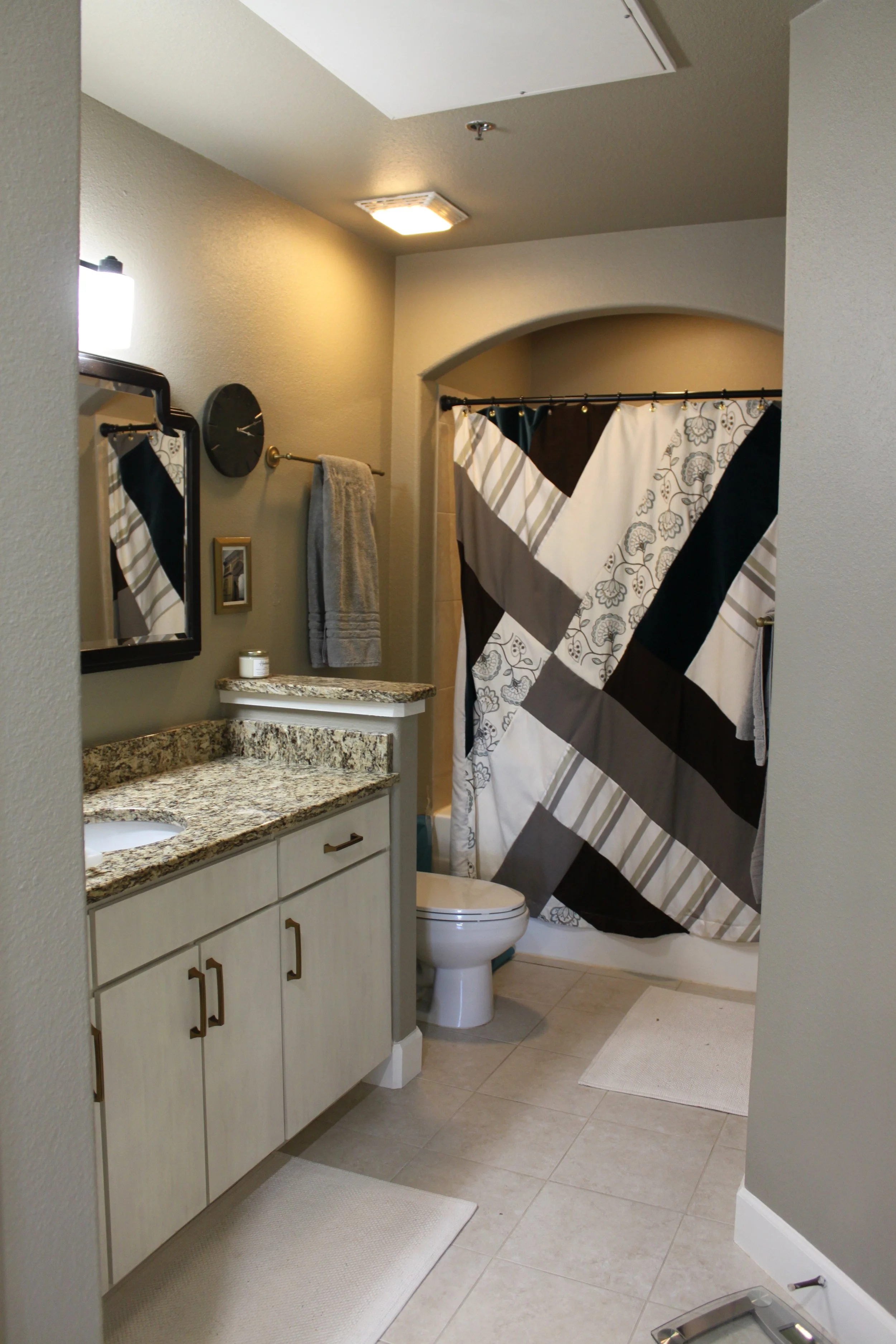 The cabinets were whitewashed and a custom shower curtain was made with leftover fabric scraps.