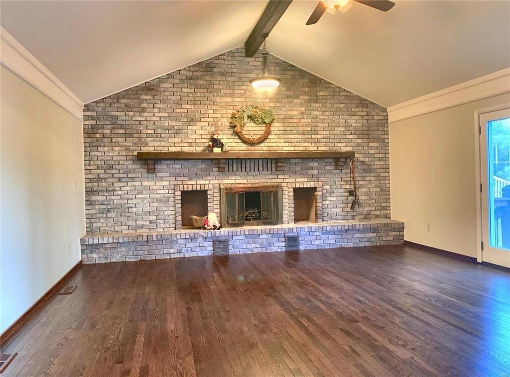 Family room after.  The entire room had to have the wallpaper taken off; it was not salvageable.  The hardwood floors were refinished, and the dark stone fireplace was whitewashed.  Updated refurbished light fixtures and crown molding were installed 
