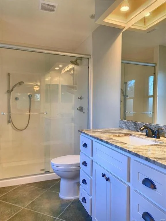 Primary bath after.  While this space didn't look like it changed too much, it needed a major cleaning, we replaced the vanity because it was unsavable, repaired broken windows, and updated the soffit by taking out the acrylic light diffuser and inst