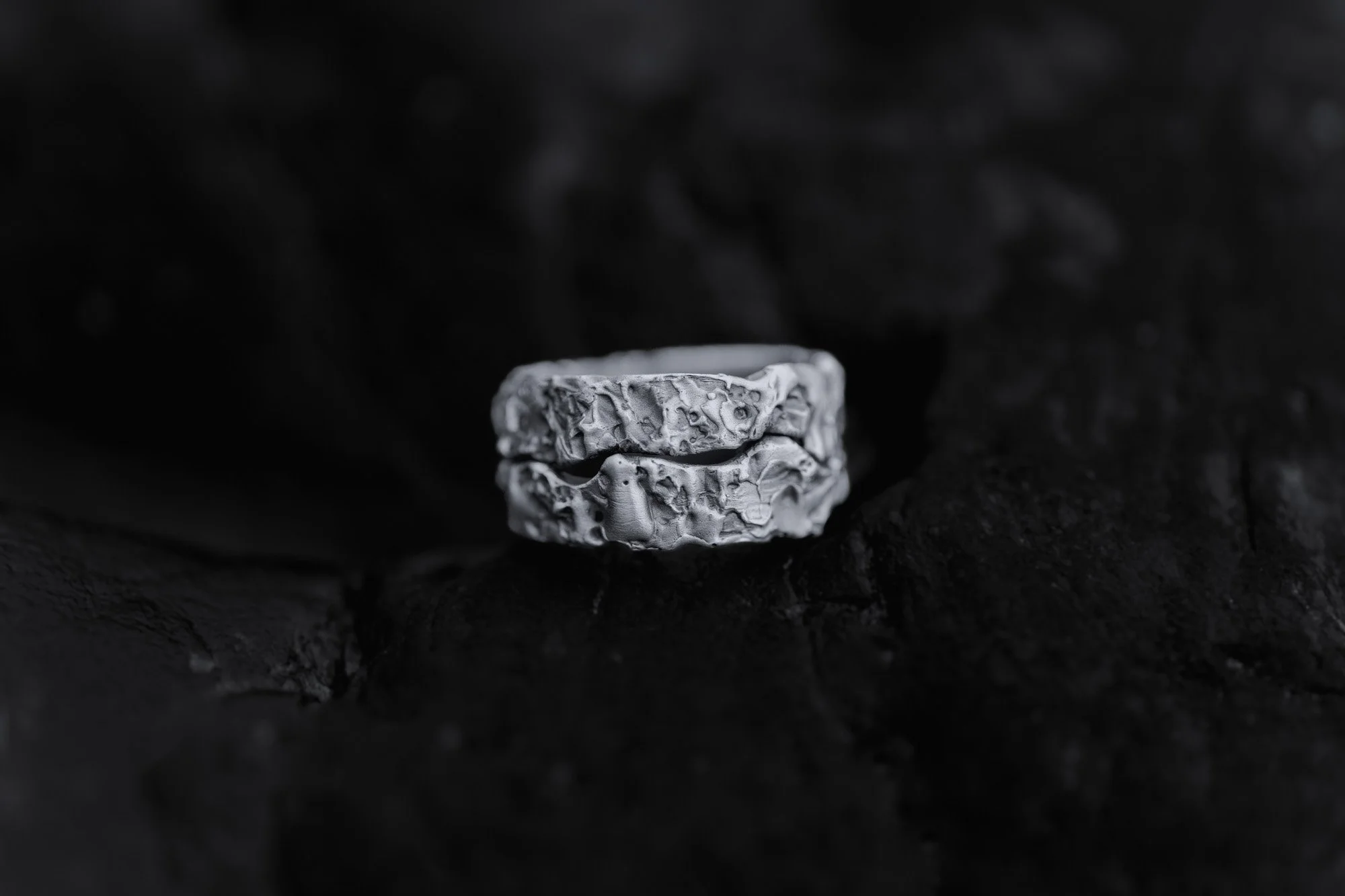 Anillo de textura rugosa sobre fondo oscuro.