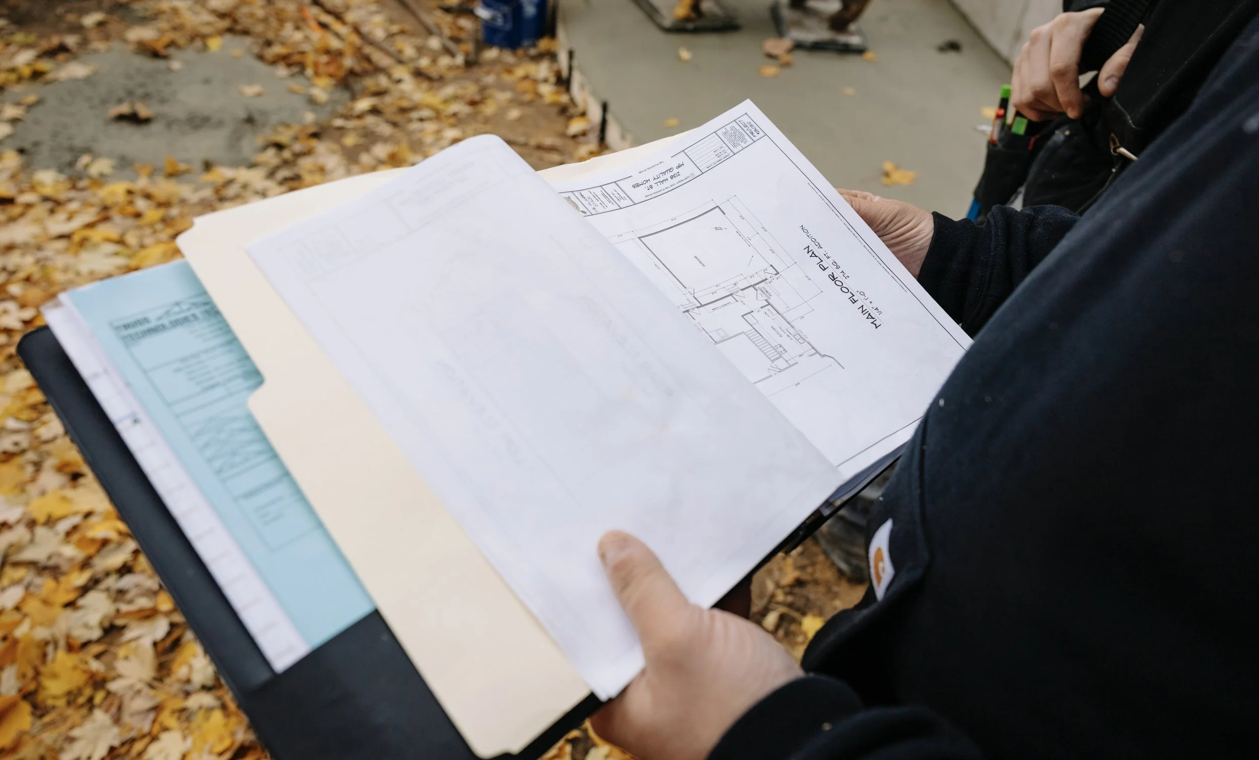 3D model of a modern house with black and wooden exterior, gabled roof, and large windows.