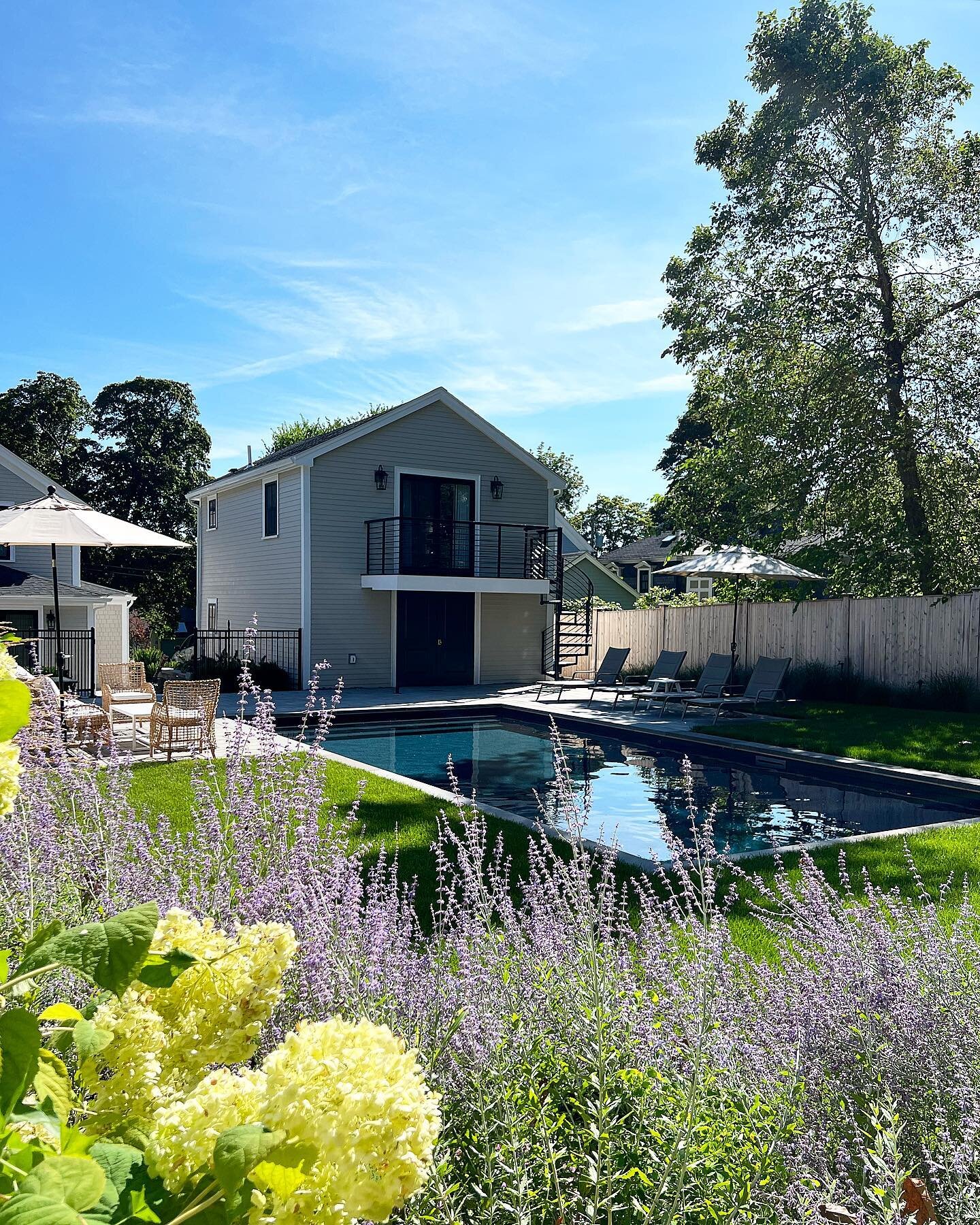 The gardens are in full bloom around this backyard oasis.