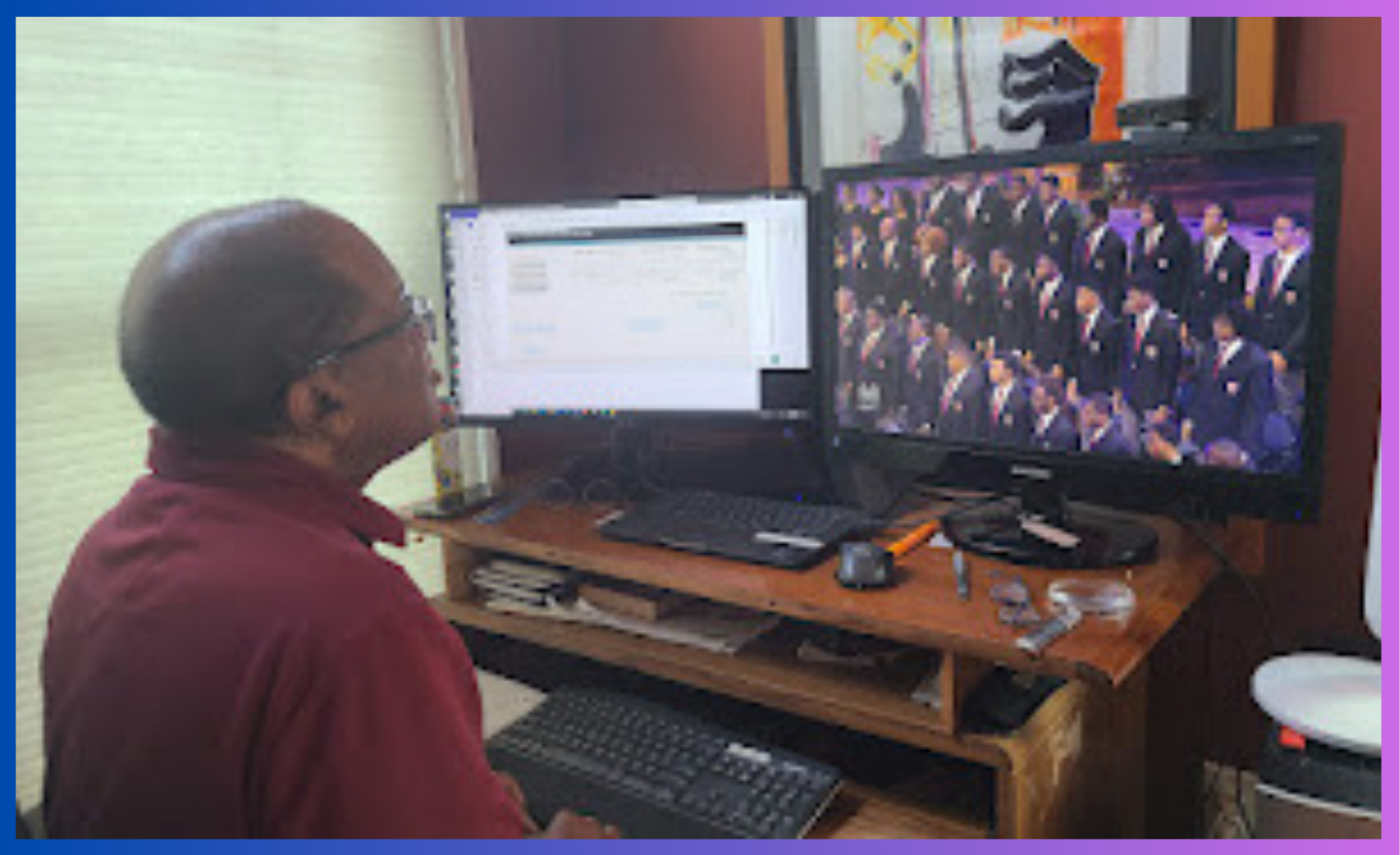 Kaden’s dad is facing away from the camera, sitting at his desk in front of double-monitors. He is watching a recording of 50 black men in suits singing in three neat rows.