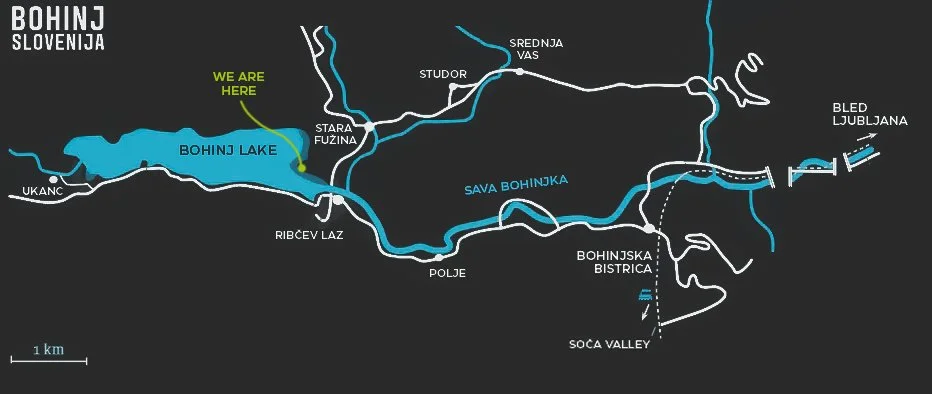 Map of Lake Bohinj in Slovenia showing surrounding areas, with a marker labeled 'WE ARE HERE' at the northern part of the lake near Stara Fužina, with nearby roads and locations including Ukanc, Ribčev Laz, Sava Bohinjka, Bohinjka Bistrica, Soča Valley, Bled Ljubljana, and various mountains and streams.