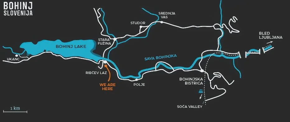 Map of Bohinj Lake in Slovenia, showing surrounding villages, streams, and attractions with a 'We Are Here' marker near Ribcev Laz.