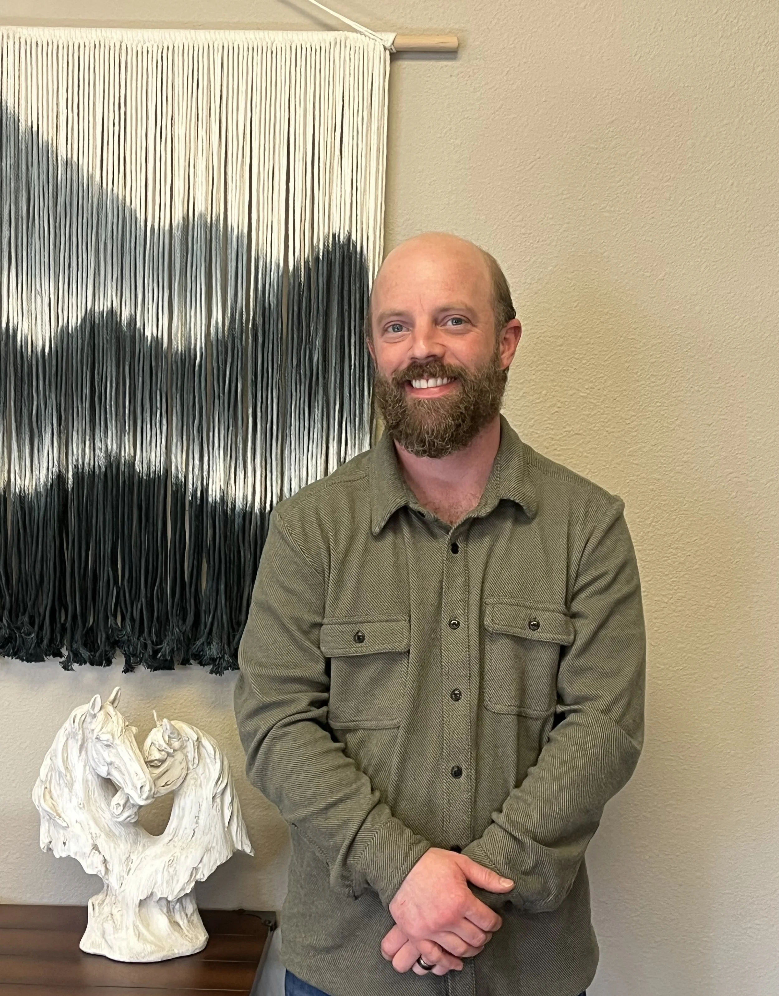 Close-up of white "COMING SOON" text on a glass window with a city street reflection.