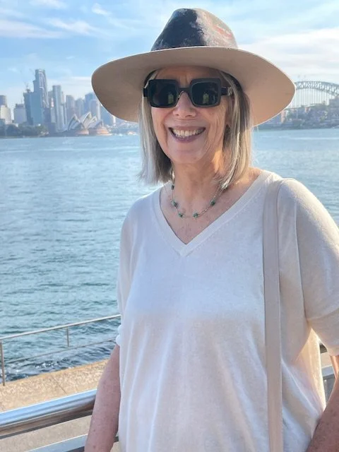 Lady wears fedora hat outside Sydney opera house