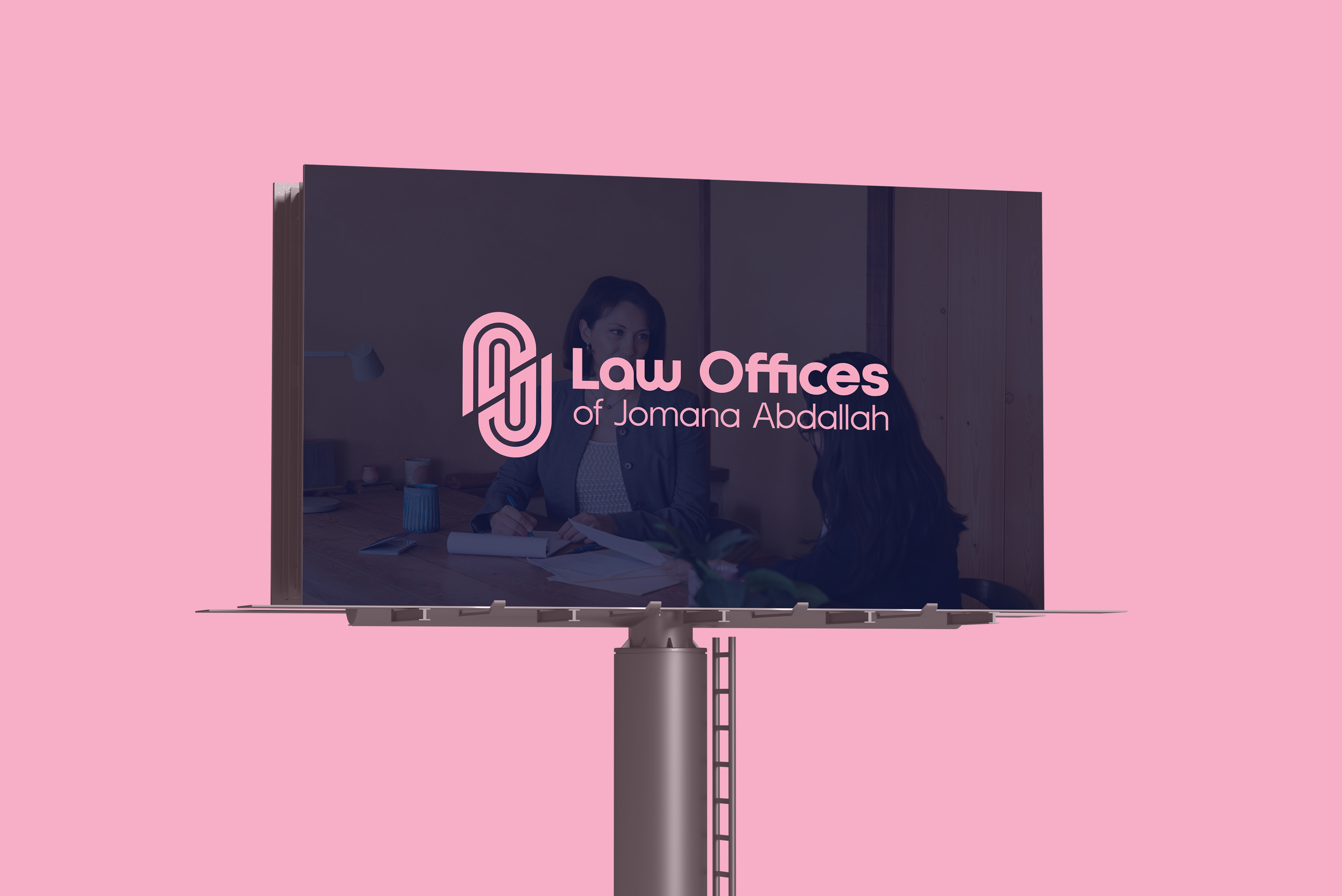 Billboard advertisement for Law Offices of Jomana Abdallah with a logo and a photo of two women in a legal consultation using a pink background.