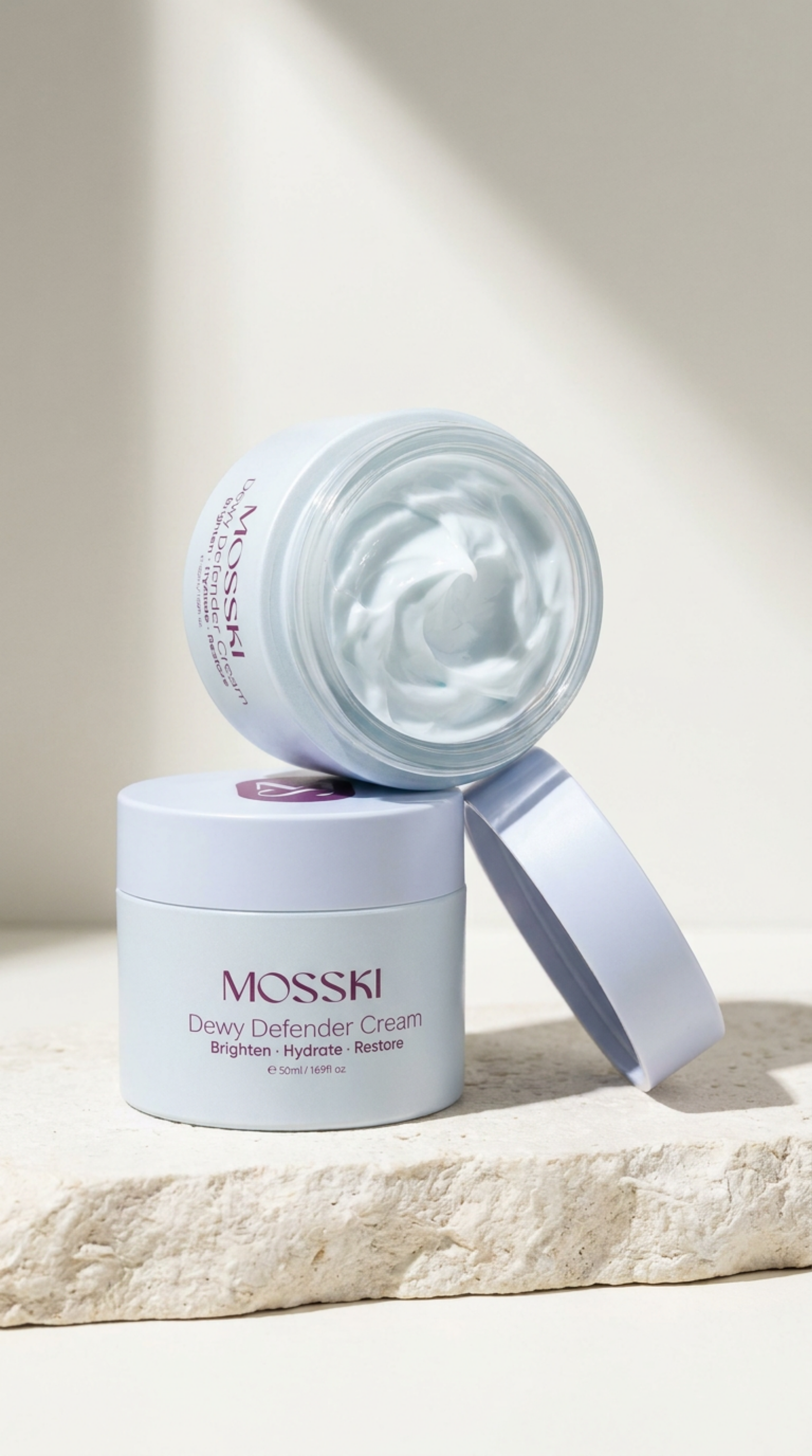A jar of MOSSKI Dewy Defender Cream with white and purple packaging, placed on a textured white surface with a small electric spatula next to it. The cream inside the jar is visible, showing a smooth, swirled consistency.